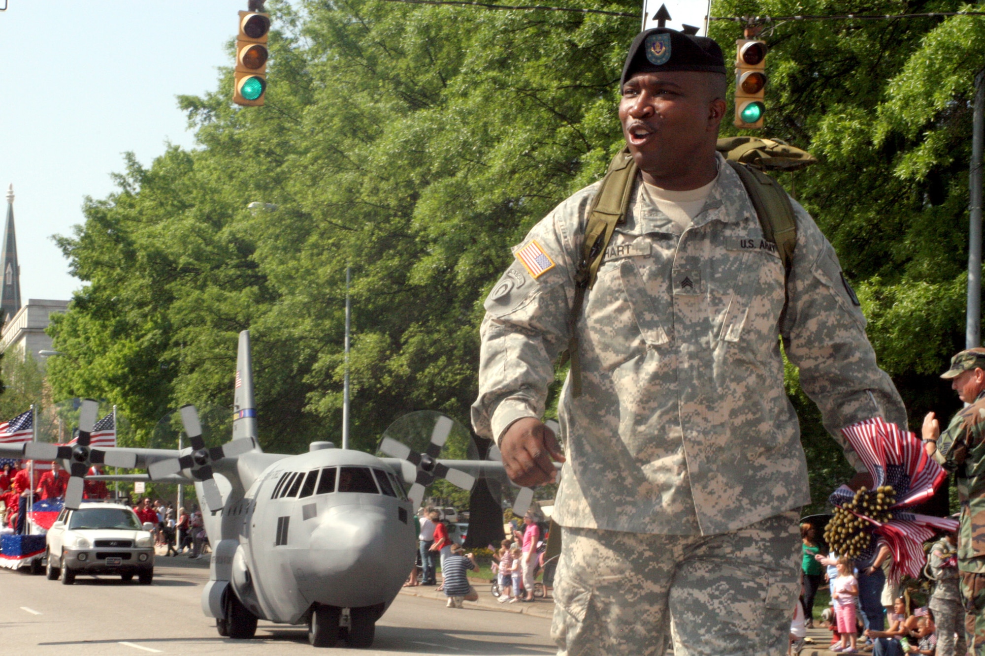 RALEIGH, N.C. - Sgt. Tomeka Hart, Co. C, 1-323rd Rgmt of the 108th Training Command in Durham marches in front of a N.C. National Guard mini C-130 for the Salute the Troops parade in Raleigh April 26. More than 50,000 spectators came to show appreciation to all of the United States Military personnel in North Carolina. (US Air Force Photo by Capt Tana R.H. Stevenson)  