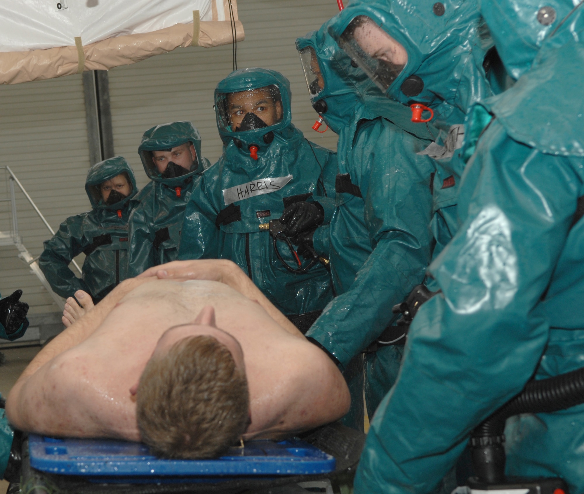 Members of the 52 MDG process moulage patients through a decontamination tent as part of exercise Saber Crown 08-06 at Spangdahelm AB, Germany, on April 23, 2008. (U.S. Air Force Photo/Staff Sergeant Heather M. Norris)