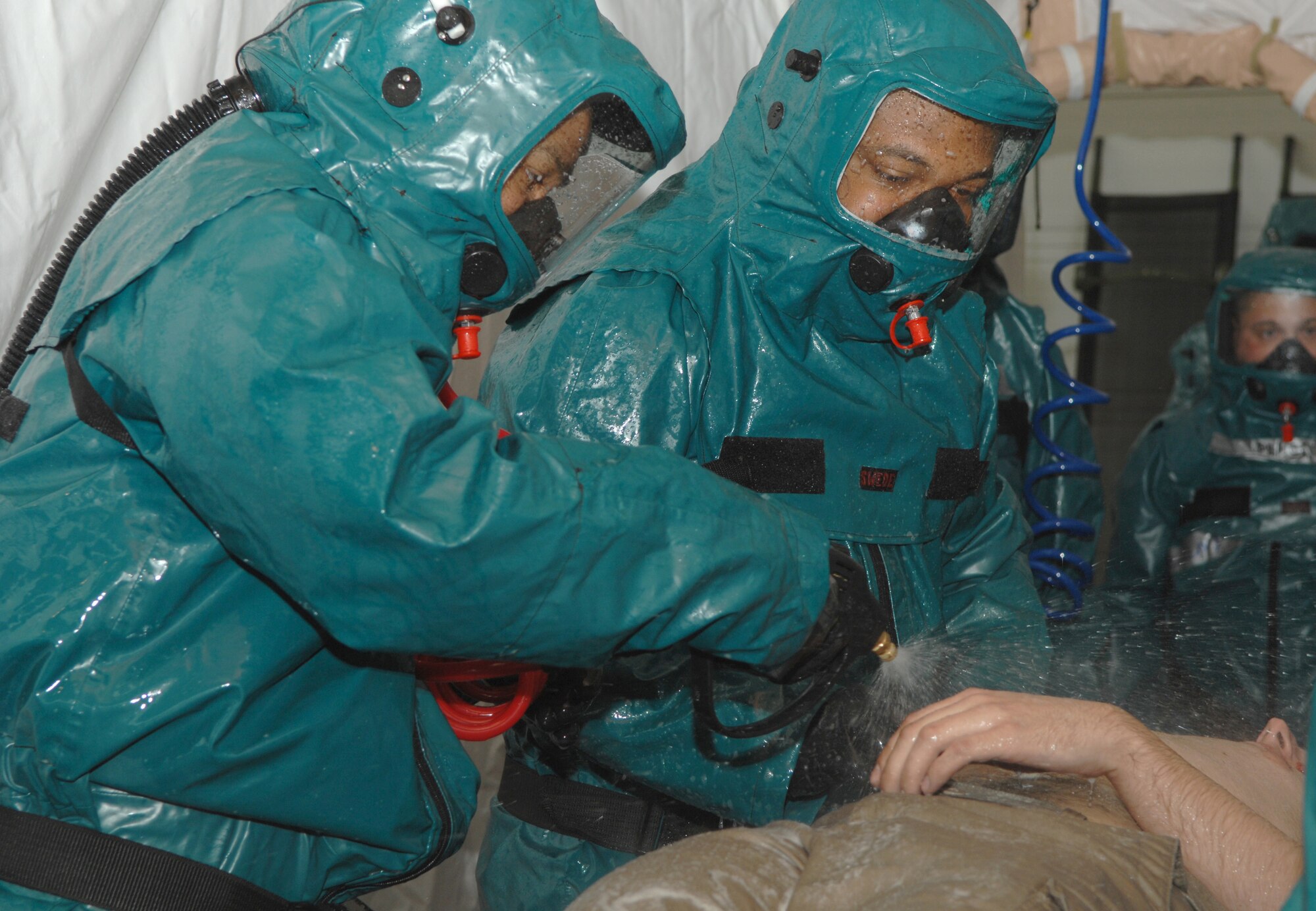 Members of the 52 MDG process moulage patients through a decontamination tent as part of exercise Saber Crown 08-06 at Spangdahelm AB, Germany, on April 23, 2008. (U.S. Air Force Photo/Staff Sergeant Heather M. Norris)