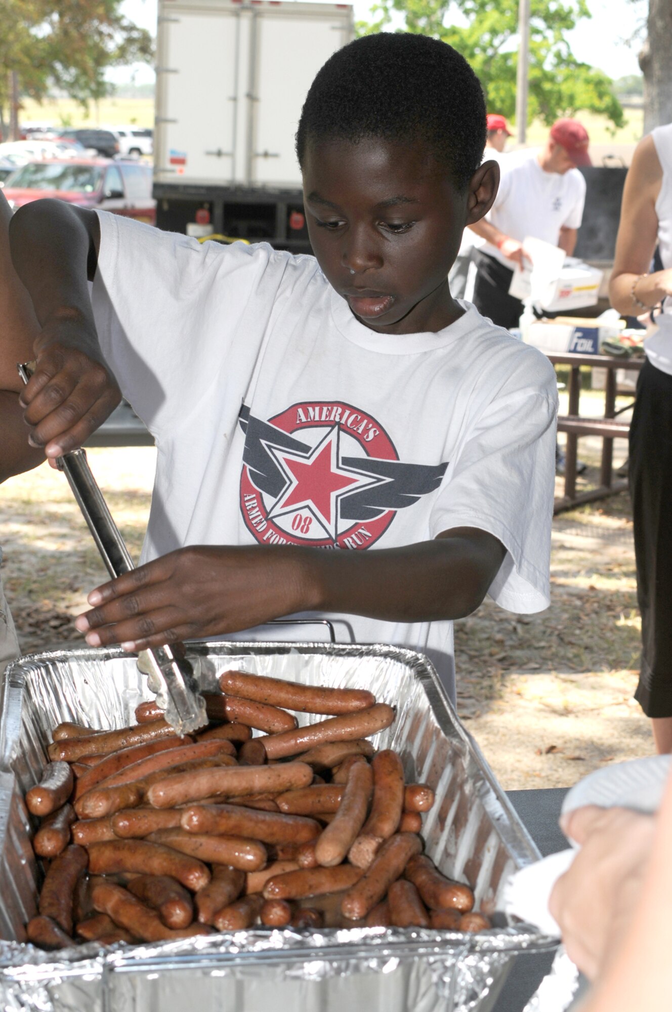 Zavier May, 10, helps himself to a hot dog.  His mom is Senior Airman Nokita May, 403rd Wing.  (U.S. Air Force photo by Kemberly Groue)