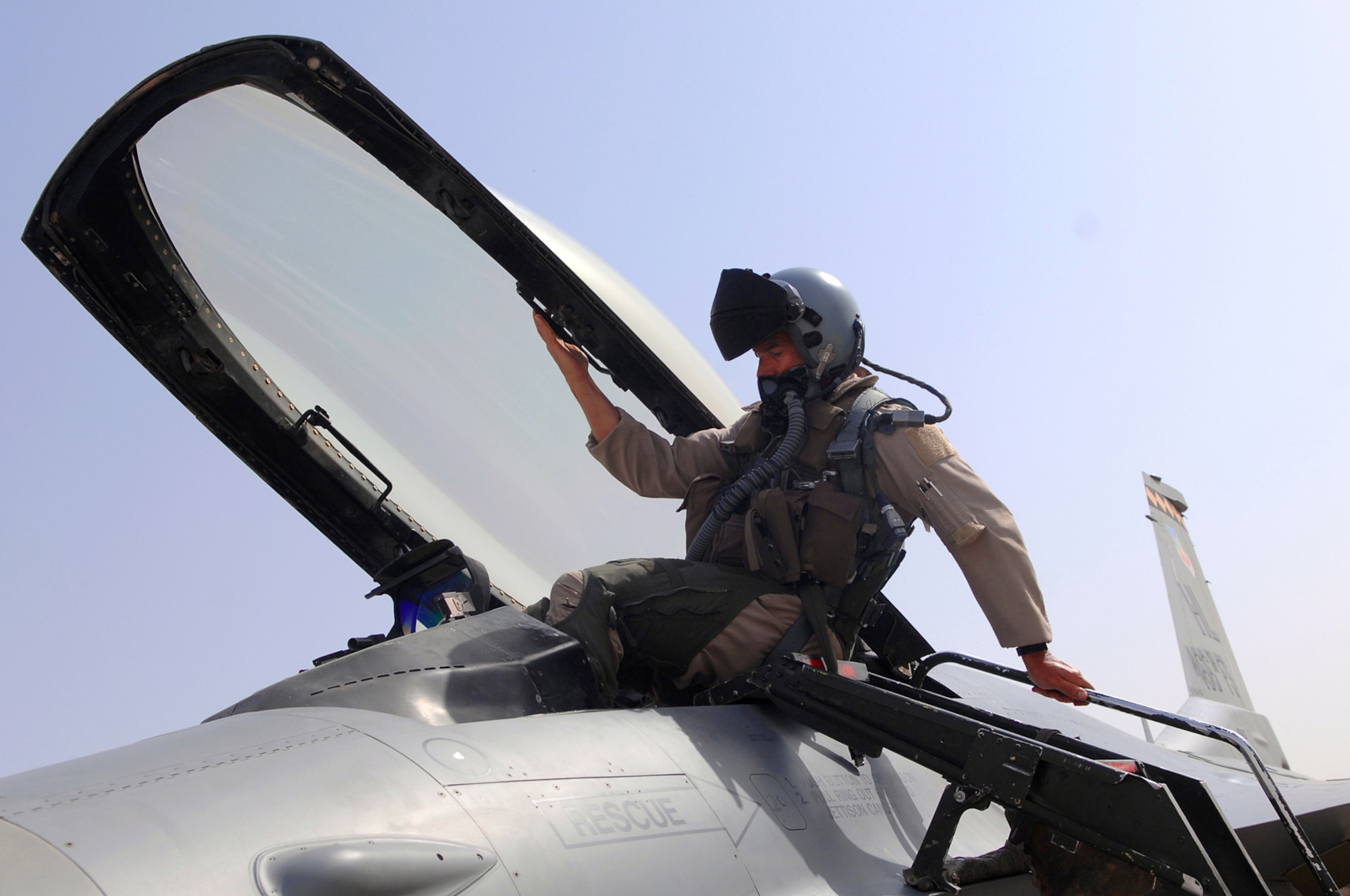 BALAD AIR BASE, Iraq -- Lt. Col. Michael Brill, a 421st Expeditionary Fighter Squadron pilot, climbs into an F-16 Fighting Falcon before flying a combat mission over Iraq here, May 2. Colonel Brill broke the world record he previously set for F-16 flying hours when he surpassed the 6,000 hours milestone. Colonel Brill is deployed from Hill Air Force Base, Utah. (U.S. Air Force photo/ Senior Airman Julianne Showalter)
