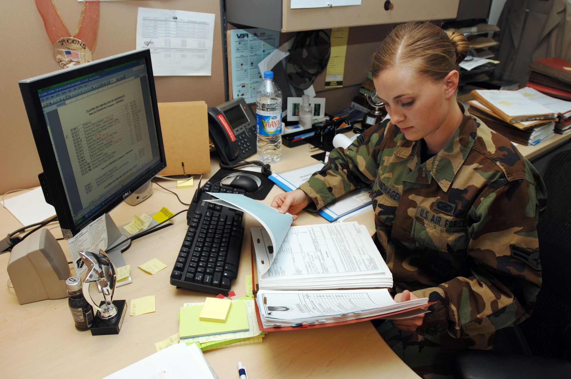 Airman 1st Class AnnMarie Strandhagen, 39th Contracting Squadron contract apprentice, reviews a contract for a new fitness center aerobics instructor to be hired. This contract is one of twelve that Airman Strandhagen handles for Incirlik Air Base. (U.S. Air Force photo by Staff Sgt. Jeff Nevison)