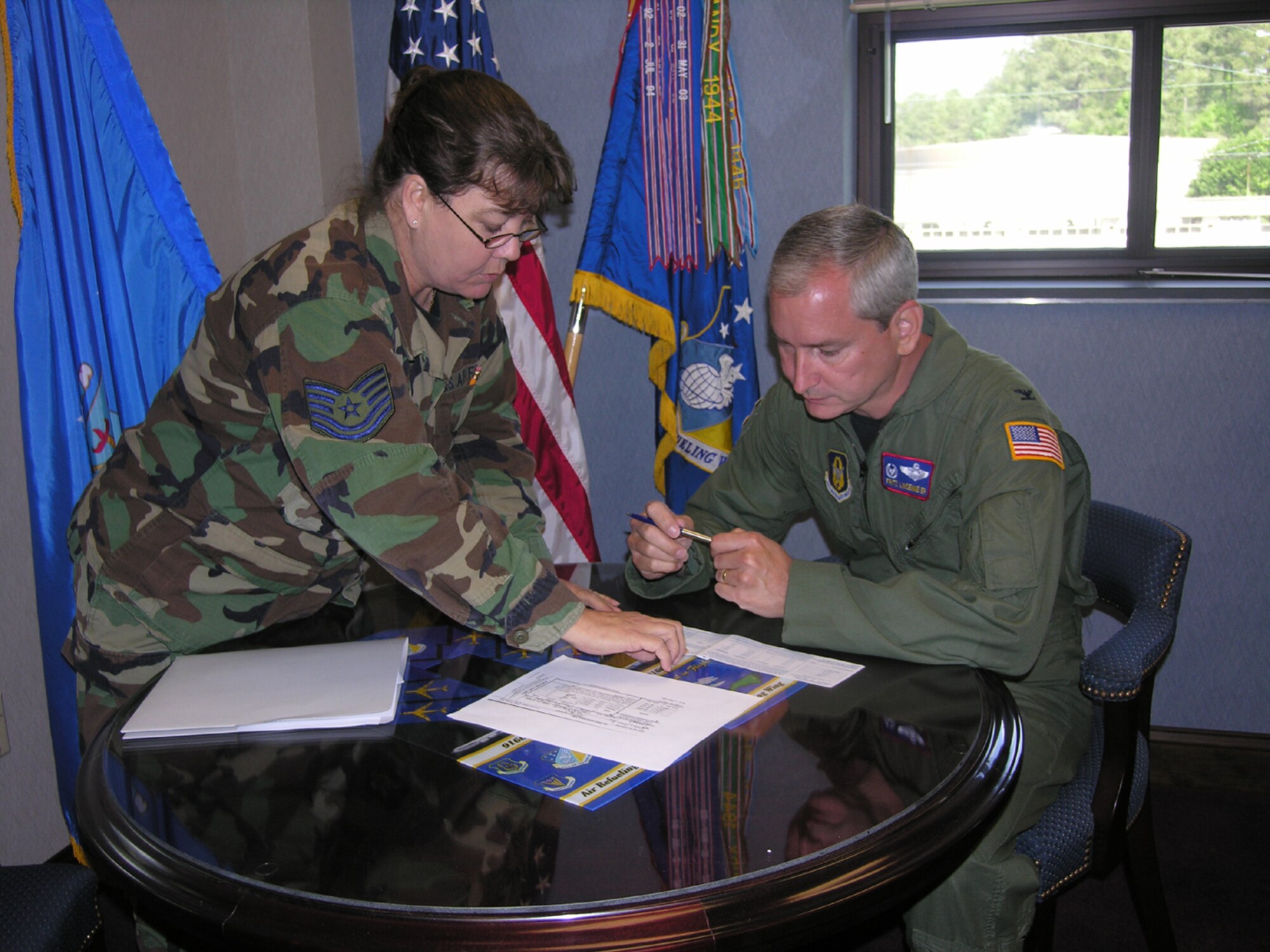 SEYMOUR JOHNSON AIR FORCE BASE, N.C. -- Tech. Sgt. Sharon Loring (left) shows Col. Fritz Linsenmeyer, wing commander,  where he needs to sign his Air Force Assistance Fund donation. The AFAF drive will continue for 916th Air Refueling Wing reservists through May 4.  U.S. Air Force photo/Ms. Donna Lea