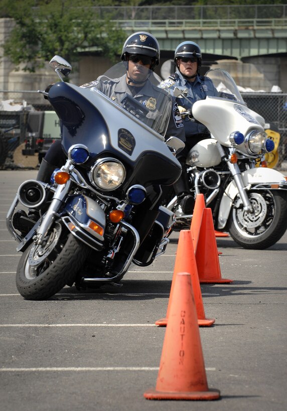Pentagon motorcycle police officer Stephen Boyd leads an Arlington County police officer through a series of cones during a cycling demonstration at the second annual National Capital Region Joint Services motorcycle safety event held at the Pentagon May 2, 2008. Photo by Fred W. Baker III, Department of Defense

