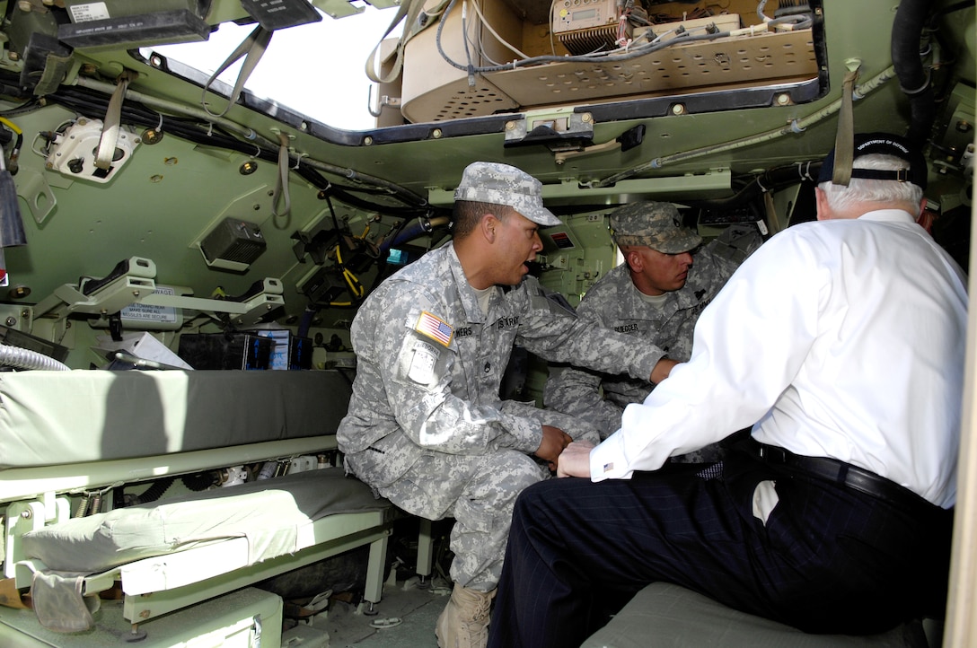 Defense Secretary Robert M. Gates looks at the interior of an M2 ...