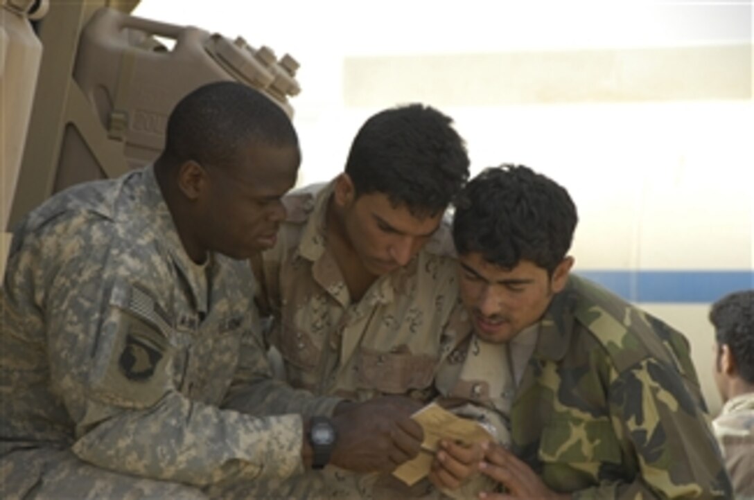 U.S. Army Capt. Antoine McKinsey (left) from 3rd Battalion, 5th Brigade teaches Iraqi army soldiers English at Combat Operating Post Mountain in Mosul, Iraq, on April 17, 2008.  The U.S. Army soldiers are moving into the operating post to be closer to the Iraqi soldiers with whom they work.  