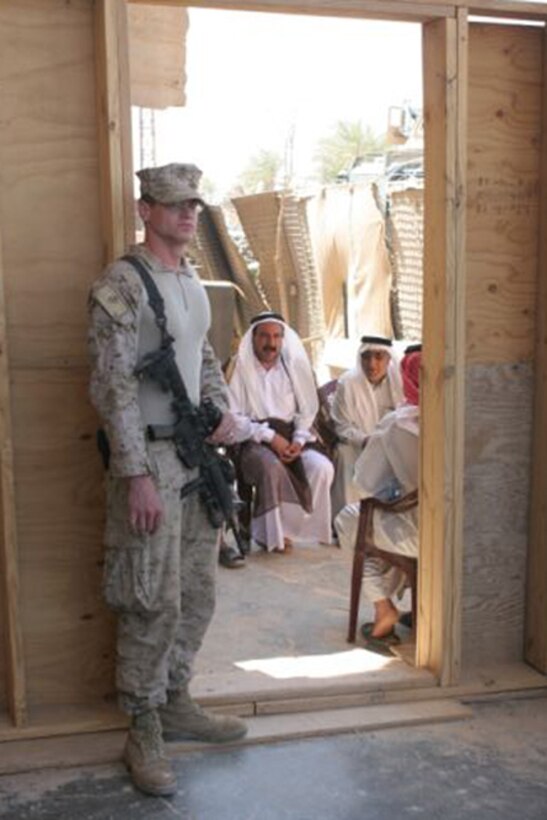 Petty Officer 3rd Class Thomas J. Cox, 24, from New Plymouth, Idaho, who is a corpsman with Civil Affairs Team 1, Detachment 1, 2nd Battalion, 11th Marine Regiment, Regimental Combat 5, waits to call the next person inside the Barwana Civil Military Operations Center May 1.  The Barwana Civil Affairs Team was relocated to Haditha, and  the Barwana government will now be responsible for the welfare of its residents.  Civil Affairs Team 1 will still check on the Barwana people occasionally, but will encourage the local government to govern themselves without support from Coalition forces.