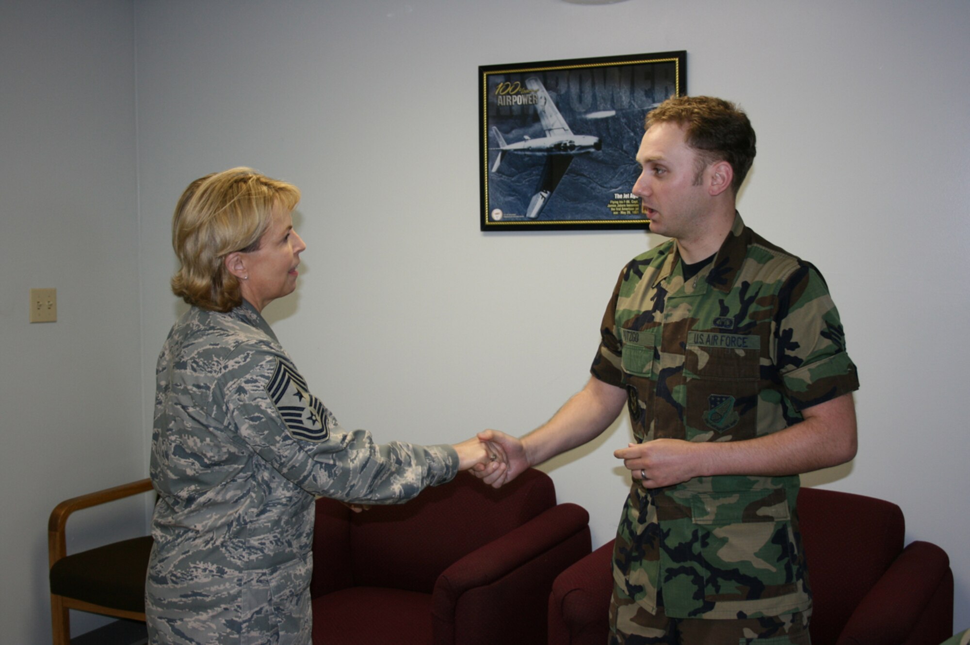 SEYMOUR JOHNSON AIR FORCE BASE, N.C. -- 4th Air Force Command Chief Master Sgt. Patricia A. Thornton presents Senior Airman George Potzgo of the 916th Communications Squadron with the 4th Air Force Command Chief Coin for outstanding service to the 916th CS.  Airman Potzgo a recent graduate of  technical school has been on seasoning training and helping the 916th CS by working various projects, programs and processes. Chief Thornton is an honored guest at the wing's annual Non-Commissioned Officer Recognition Ceremony to be held this evening on-base.