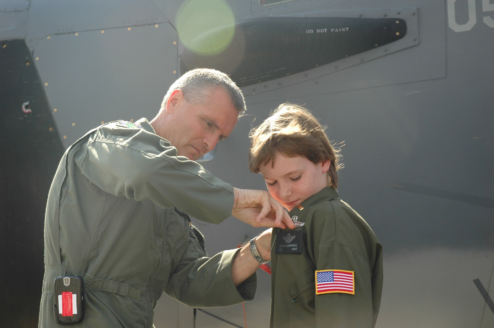 Col. Steven J. Chapman, 919th Special Operations Wing commander, pins on 2nd Lt. Ethan Campbell's pilot's wing shortly after completing a runway taxi on an MC-130E Combat Talon I aircraft during Pilot for a Day at Duke Field May 2. The 10-year-old honorary pilot is diagnosed with leukemia. The Pilot for a Day program gives children with serious health conditions a break from treatments to experience a day in the life of an Air Force pilot. (U.S. Air Force Photo/Jasmine DeNamur)