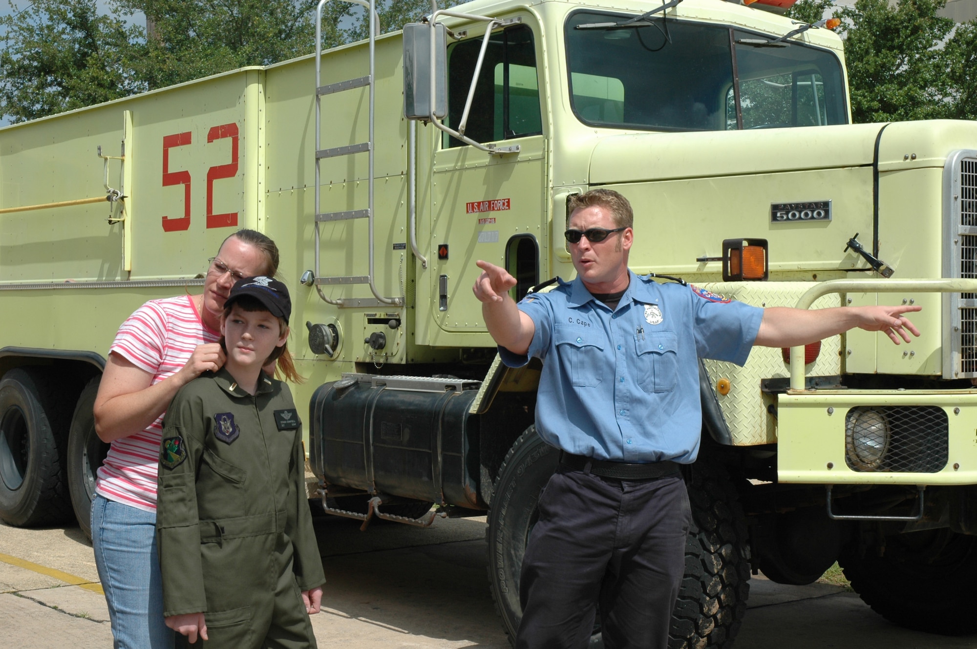 Christopher Cape (right), 96th Civil Engineering Squadron fire fighter, explains the unique capabilities of the squadron's fire truck fleet to Honorary 2nd Lt. Ethan Campbell and his mother Brenda during Pilot for a Day at Duke Field May 2.The Pilot for a Day program gives children with serious health conditions a break from treatments to experience a day in the life of an Air Force pilot. Lieutenant Campbell was also experienced a simulator ride, battled insurgents with security forces members, and taxied down a runway in an MC-130E Combat Talon I aircraft where he was then given his pilot's wings. (U.S. Air Force Photo/Jasmine DeNamur)