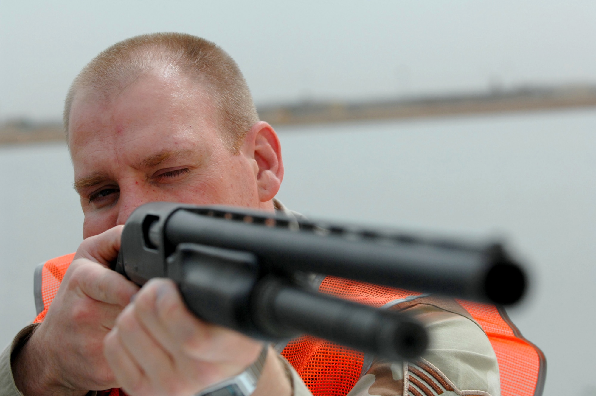 BALAD AIR BASE, Iraq -- Tech. Sgt. David Young, 332nd Air Expeditionary Wing noncommissioned officer in charge of flight safety, takes aim at a group of gulls to reduce the number of birds at Balad AB, where aircraft take off and land 24/7. Collisions between flying birds and aircraft can severely damage aircraft and endanger the lives of pilots. To reduce the number of collisions, the 332nd Air Expeditionary Wing Safety Office personnel depredate the birds on the base. On May 3, the remains of whole, depredated birds were shipped from the base to the Smithsonian Institution, National Museum of Natural History, Feather Identification Laboratory in Washington, D.C., to be analyzed by scientists there. This marks the first shipment of whole bird remains to be sent from Iraq to the Smithsonian. Sergeant Young is deployed from Elmendorf Air Force Base, Alaska. (U.S. Air Force photo/ Senior Airman Julianne Showalter)