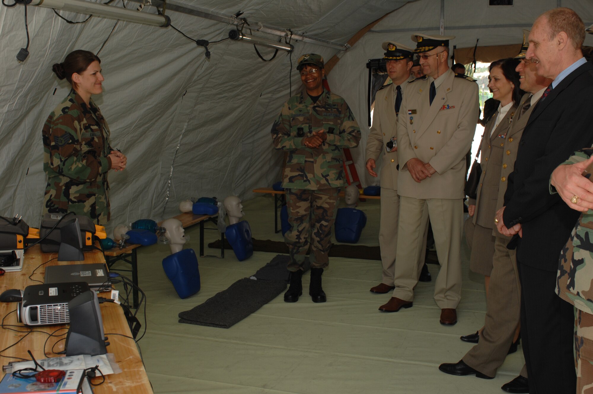 DIVULJE TRAINING BASE, Croatia – U.S. Air Force Staff Sgt. Korrine Kargl explains training techniques to Croatian and MEDCEUR leadership during the 2008 Medical Training Exercise in Central and Eastern Europe (MEDCEUR).  Kargl is deployed from Ramstein Air Base, Germany.  Fifteen nations are participating in the exercise from May 2 through 14. The exercise focuses on mass-casualty training scenarios and humanitarian aid in response to crises situations. More than 400 multi-nationals are attending the exercise in support of the Partnership for Peace initiative. (U.S. Air Force photo/Staff Sgt. Kristin Ruleau) 