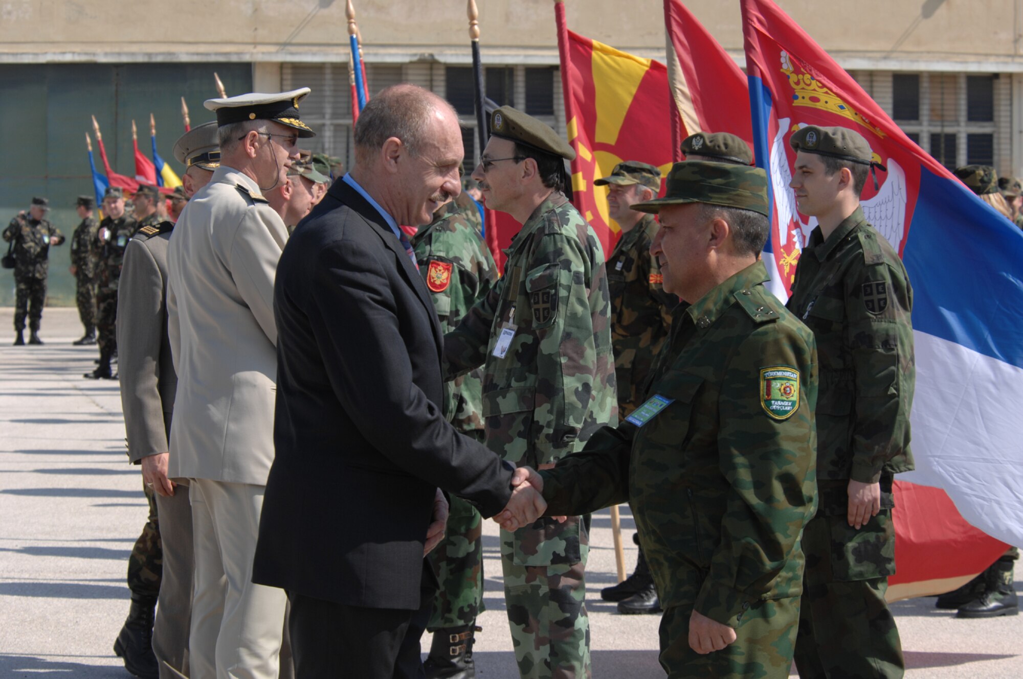 DIVULJE TRAINING BASE, Croatia – Croatian State Secretary of Defense Mate Raboteg takes a moment to greet 1st Lt. Aman Merevov of the Turkmenistan Ministry of Emergency Situations (MES) during the opening ceremony of the 2008 Medical Training Exercise in Central and Eastern Europe (MEDCEUR).  Fifteen nations are participating in the exercise from May 2 through 14. The exercise focuses on mass-casualty training scenarios and humanitarian aid in response to crises situations. More than 400 multi-nationals are attending the exercise in support of the Partnership for Peace initiative. (U.S. Air Force photo/Staff Sgt. Kristin Ruleau)