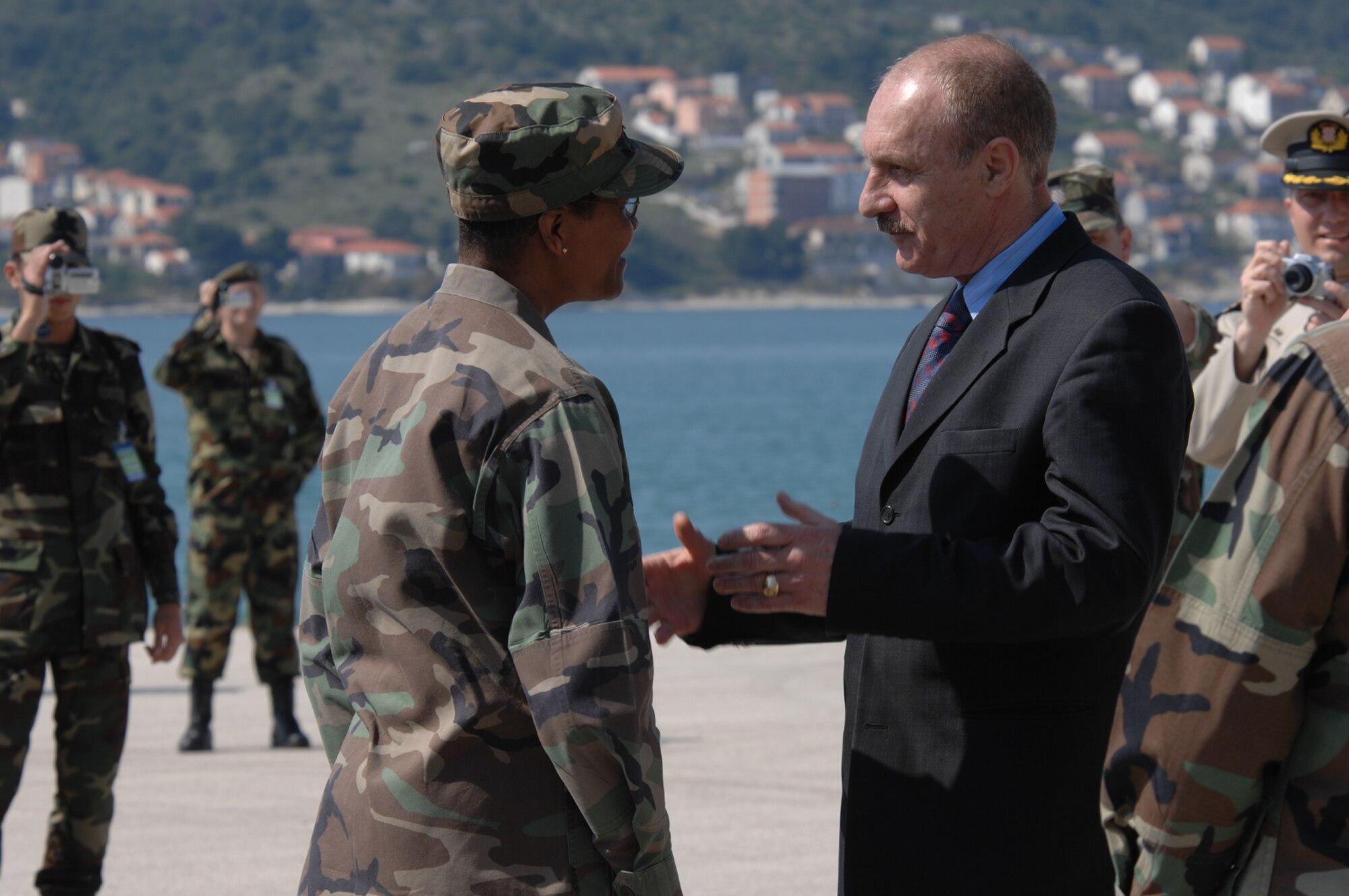 DIVULJE TRAINING BASE, Croatia – Croatian State Secretary of Defense Mate Raboteg takes a moment to greet U.S. Air Force Colonel Angela Thompson, 458th Expeditionary Medical Squadron commander, during the opening ceremony of the 2008 Medical Training Exercise in Central and Eastern Europe (MEDCEUR).  Thompson is deployed from Ramstein Air Base, Germany.  Fifteen nations are participating in the exercise from May 2 through 14. The exercise focuses on mass-casualty training scenarios and humanitarian aid in response to crises situations. More than 400 multi-nationals are attending the exercise in support of the Partnership for Peace initiative. (U.S. Air Force photo/Staff Sgt. Kristin Ruleau)