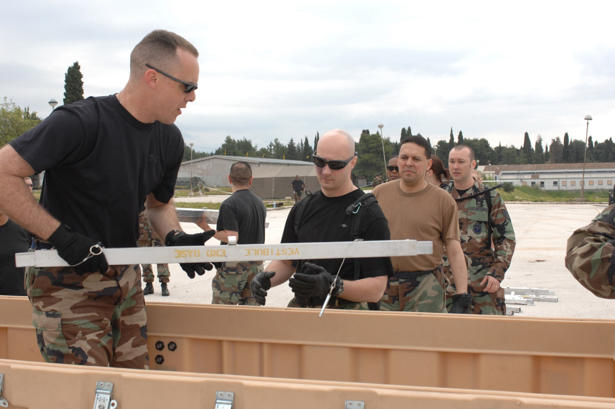 DIVULJE TRAINING BASE, Croatia – U.S. Air Force Lt. Col. Jeff White, 435th Medical Support Squadron, hands out tent beams April 30. The tents are Expeditionary Medical Squadron (EMEDS) +10 tents designed to provide patient care for ten or more people as a mobile field hospital. White is deployed from Ramstein Air Base, Germany, for the 2008 Medical Training Exercise in Central and Eastern Europe (MEDCEUR).  Fifteen nations are participating in the exercise from May 2 through 14. The exercise focuses on mass-casualty training scenarios and humanitarian aid in response to crises situations. More than 400 multi-nationals are attending the exercise in support of the Partnership for Peace initiative. (U.S. Air Force photo/Staff Sgt. Kristin Ruleau) 