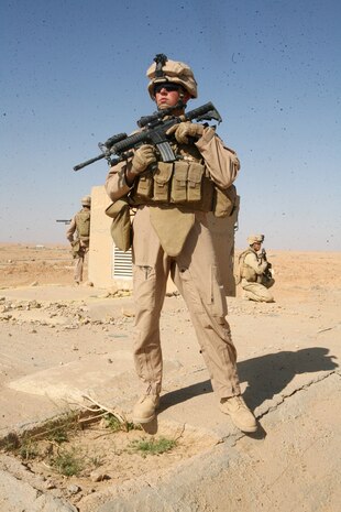 Providing security, Lance Cpl. Anthony R. Robertson, a scout with Charlie Company, 2nd Light Armored Reconnaissance Battalion, Regimental Combat Team 5, maintains his alertness during a bunker-searching operation in western Anbar province, May 2. Marines with Charlie Company, known as 'Gunfighter,' searched the deep, dark, corners of western Anbar province for weapons caches