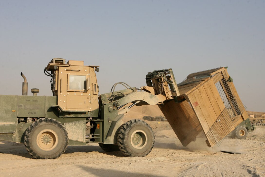 Marines with Support Platoon, 3rd Combat Engineer Battalion, Regimental Combat Team 5, move an old guard post used by Iraqi Army in Baghdadi, May 4. The Marines are demilitarizing a schoolhouse which the IA now occupy and are building a new traffic control point across the street. The schoolhouse is scheduled to be complete in August, one month prior to the beginning of the new school year.