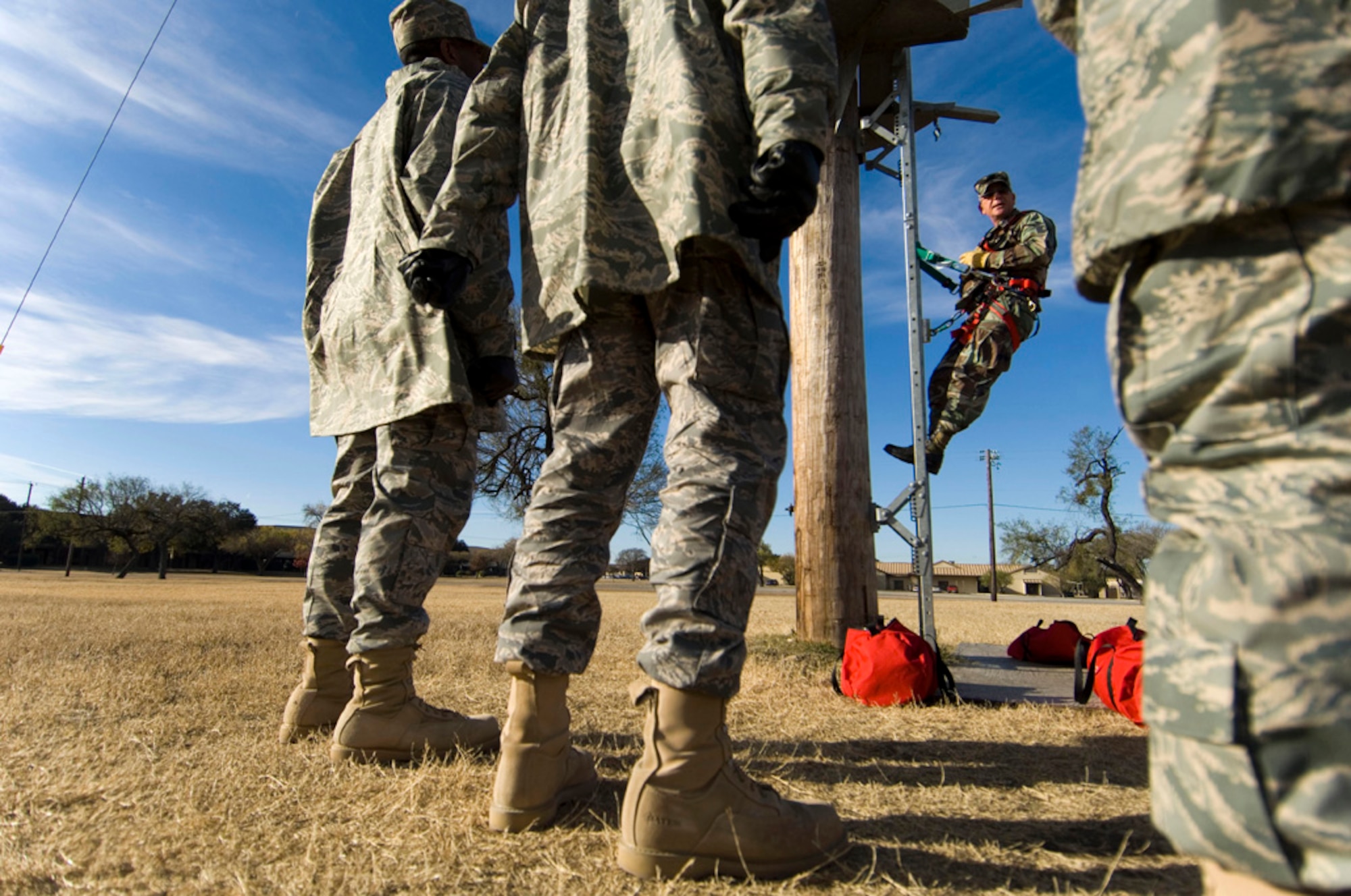 Acrophobia evaluator Tech. Sgt. Michael Fettis demonstrates how to climb a 50-foot pole, so basic trainees can accomplish the task without losing their balance or losing their cool while battling a fear of heights. (photo by Tech. Sgt. Matthew Hannen)