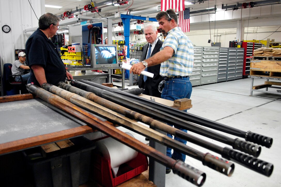 Defense Secretary Robert M. Gates tours the Bradley Transmission and 25-millimiter gun production facility with Joe Bell, turret and final test section chief, at Red River Army Depot in Texarkana, Texas, May 2, 2008.
