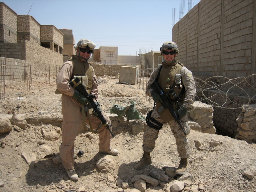 Cmdr. Larry M. Young (left) and Lt. Cmdr. Steve A. Penley (right), both are electronic warfare officers for Regimental Combat Team 5, stop for a moment while on a patrol in Hit, Iraq, May 5, while they were monitoring radio units in the area. Young has been deployed to Al Asad, Iraq, since August 2007 and will soon return to the Navy staff at the Pentagon. Penley is replacing Young as the EWO for RCT-5 and is scheduled to remain here until later this year.
