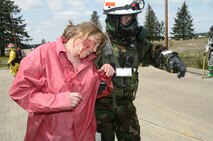 Cpl. Alexandro Gachupin, litter bearer, and Sgt. Jorge Diaz, extractor, both with Decontamination Platoon, Company B, Chemical Biological Incident Response Force, II Marine Expeditionary Force, ensure a simulated casualty who cannot walk is safely put on the decontamination line May 4 during exercise Ardent Sentry 08. The exercise is the annual North American Aerospace Defense Command and United States Northern Command Defense Support of Civil Authorities exercise incorporated into NLE 2-08.,