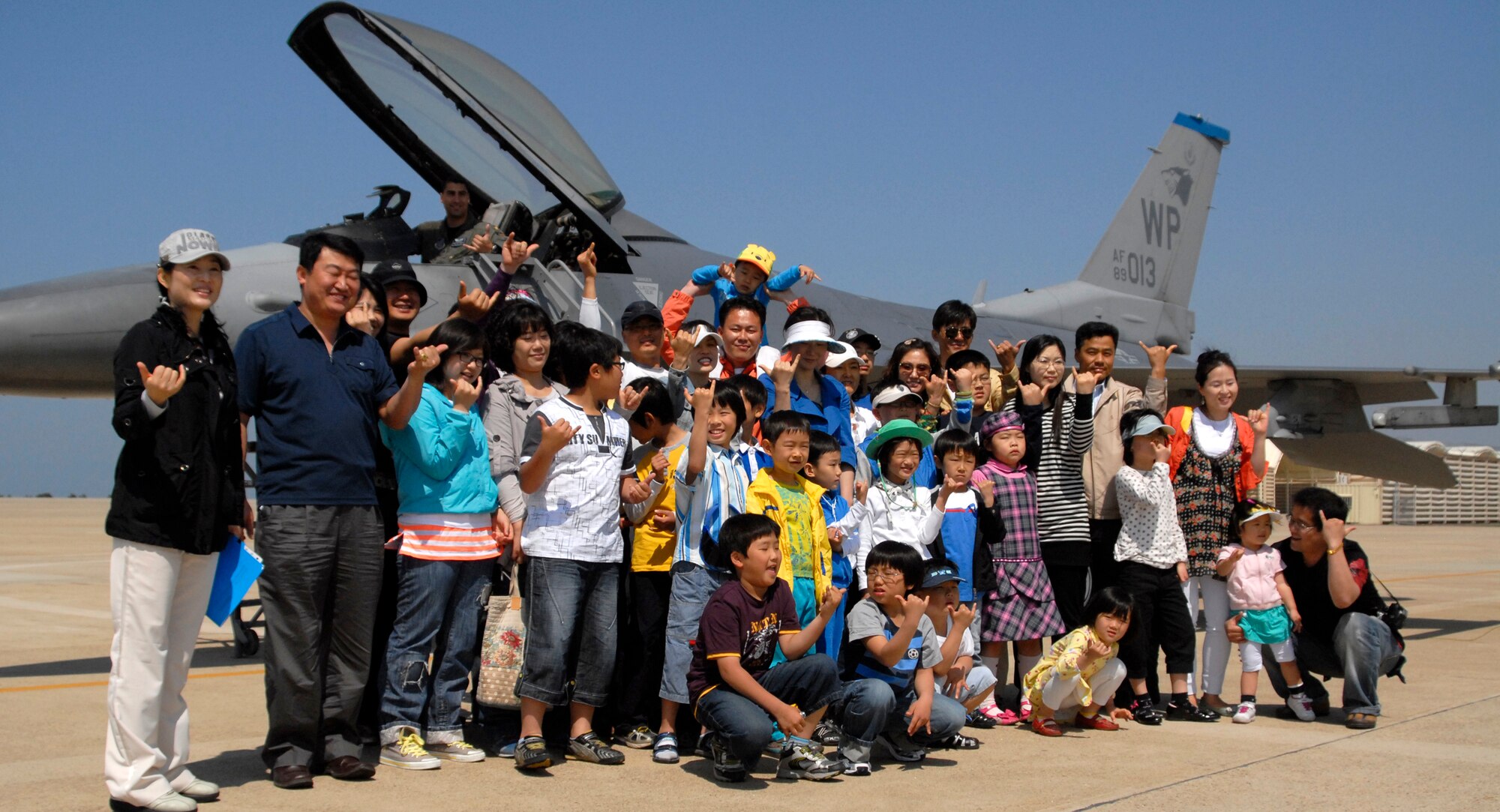 KUNSAN AIR BASE, Republic of Korea – Members from the local Retired Korean Reserve Officers’ Training Corps (ROTC) pose in front of an F-16 for a group photo here May 5. The base hosted a tour for ROTC members in celebration of Children's Day, a Korean holiday, allowing members and their families an opportunity see an F-16 up close, tour the fire station and K-9 Kennel.  (U.S. Air Force photo / Senior Airman Dana D. Hill)