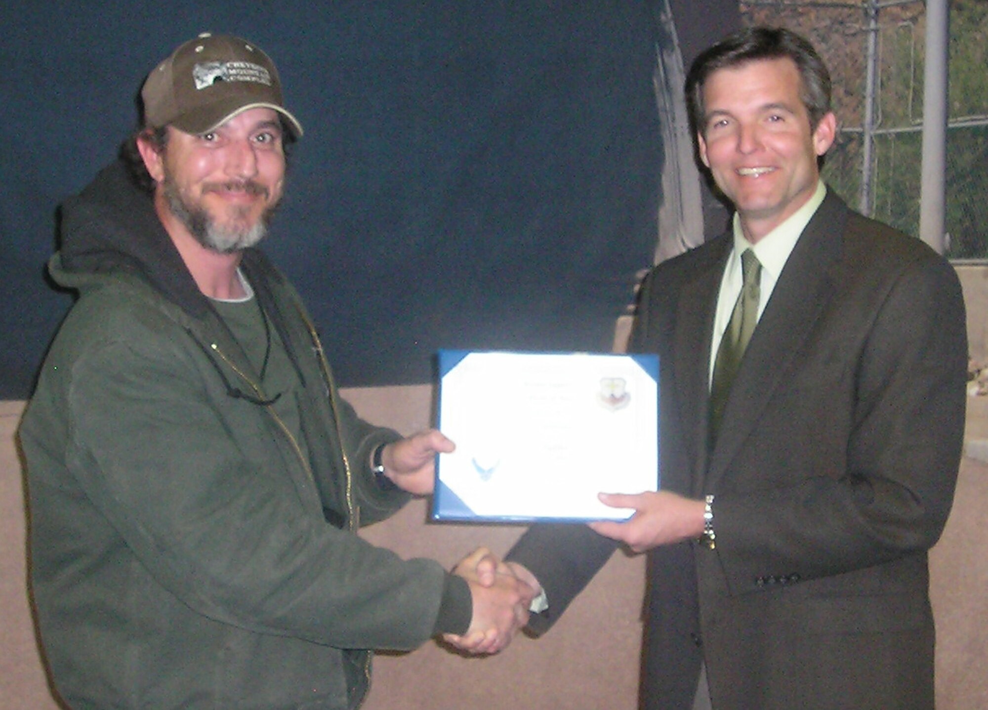 Roy Audibert is presented the Cheyenne Mountain Air Force Station Conservation Award by Robert Wynn, 721st Mission Support Group deputy commander April 22. Mr. Audibert submitted the winning conservation idea that involves retrofitting lights in industrial areas, projected to save CMAFS $11,000 a year. The event helped to raise awareness of environmental issues and energy conservation techniques through demonstration booths sponsored by local organizations and businesses.  The demonstrations were geared toward what individuals could do personally to conserve on energy. The installation, located in southern Colorado, operates, maintains, secures, sustains, mobilizes, tests and controls the worldwide warning and surveillance system for North America. The Integrated Tactical Warning and Attack Assessment weapon system is airborne, land- and space-based and can sense and report on all activities in air and space. (U.S. Air Force photo/Tech. Sgt. Christopher Campbell)