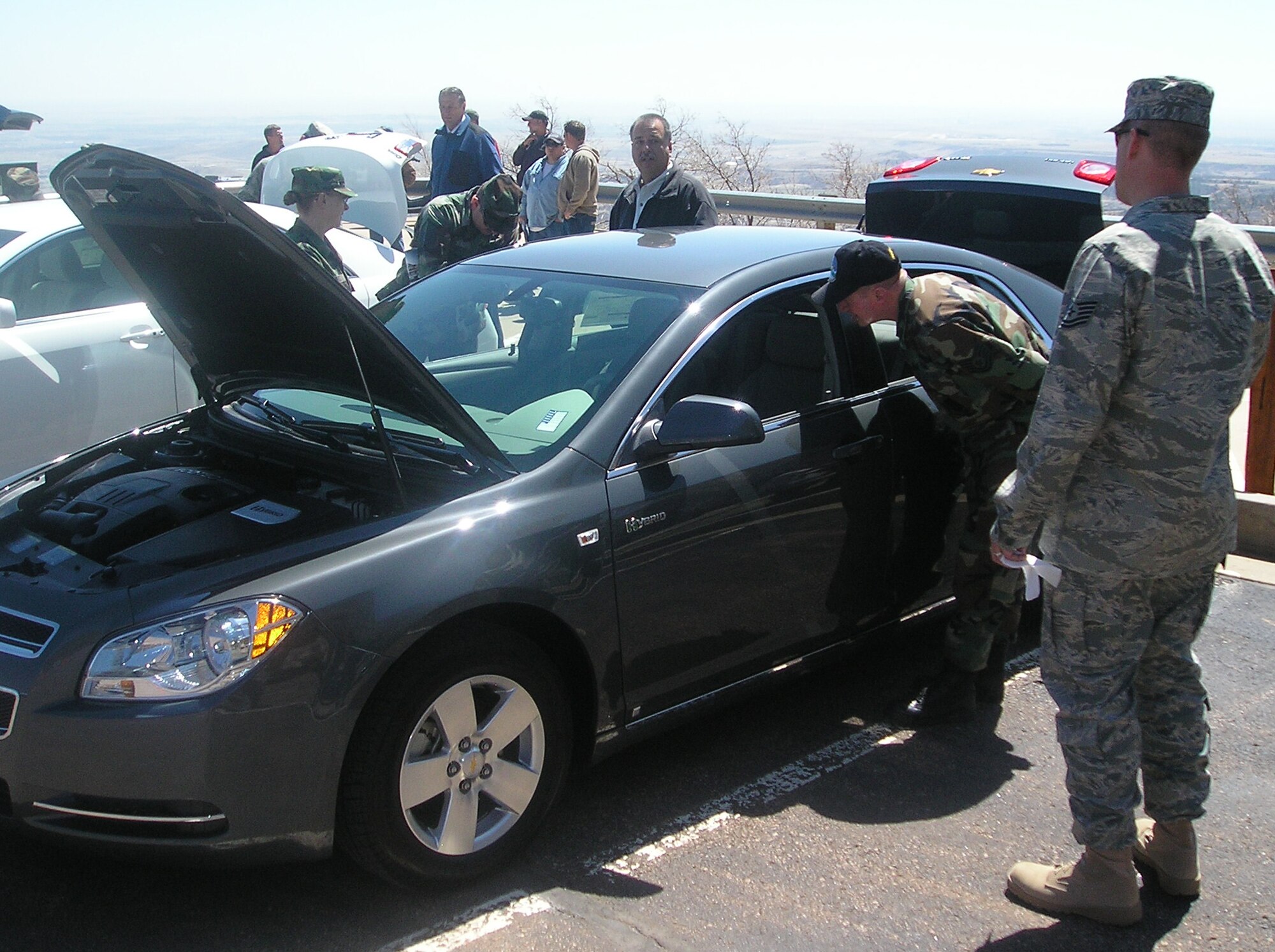 Tech. Sgts. Jeffrey Wulfekuhl (right) and Jay Mitchell look inside a new Hybrid Chevy April 22 at Cheyenne Mountain Air Force Station’s Earth Day events. The event helped to raise awareness of environmental issues and energy conservation techniques through demonstration booths sponsored by local organizations and businesses.  The demonstrations were geared toward what individuals could do personally to conserve on energy. The installation, located in southern Colorado, operates, maintains, secures, sustains, mobilizes, tests and controls the worldwide warning and surveillance system for North America. The Integrated Tactical Warning and Attack Assessment weapon system is airborne, land- and space-based and can sense and report on all activities in air and space. (U.S. Air Force photo/Tech. Sgt. Christopher Campbell)