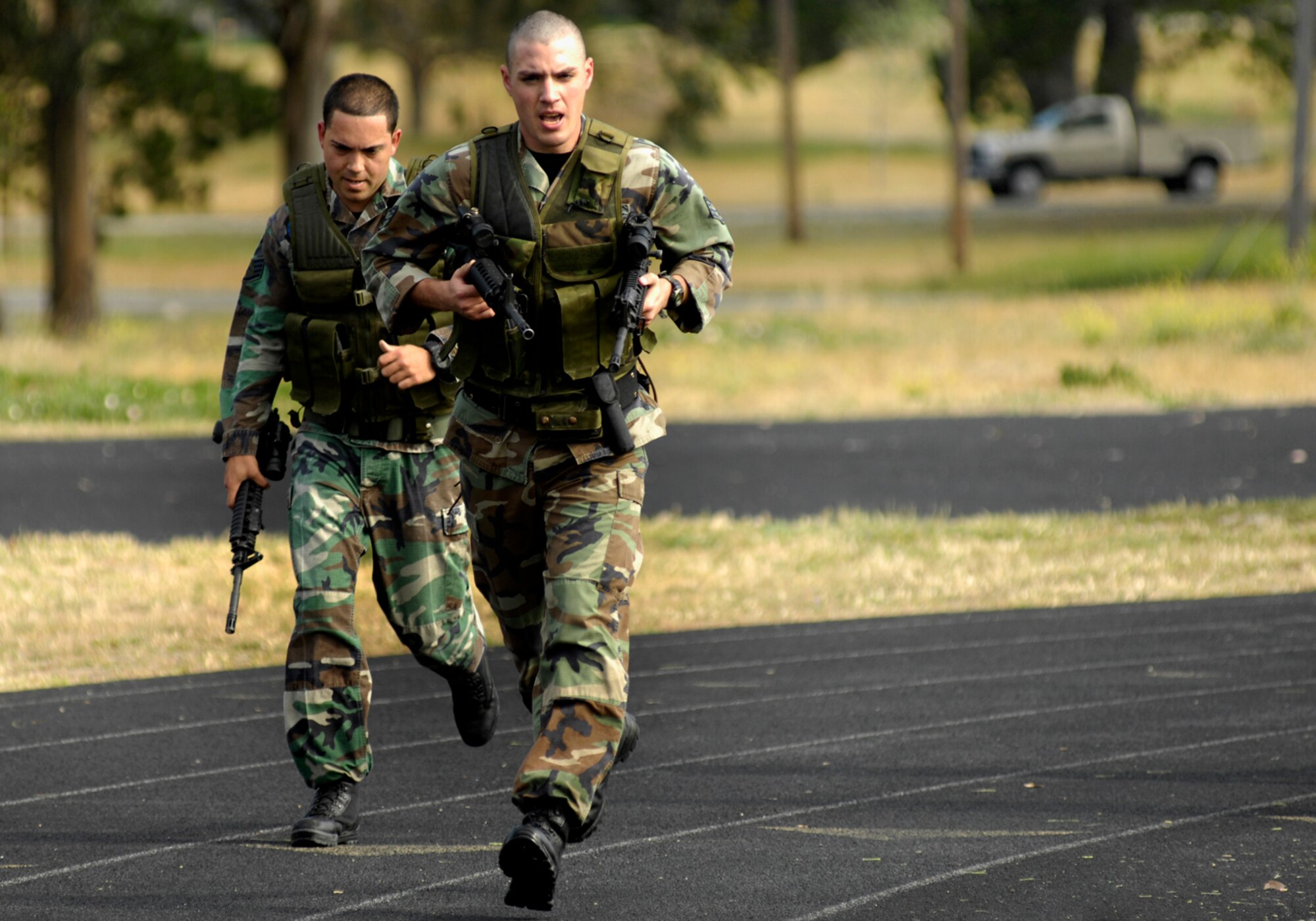 VANDENBERG AIR FORCE BASE, Calif. --  Staff Sgts. Tony Perez (left) and Sean Storms, both with the 30th Security Forces Squadron, participate in the Fitness Challenge/Station Challenge portion of the Guardian Challenge at the base track on May 5. (U.S. Air Force photo/Airman 1st Class Jonathan Olds)