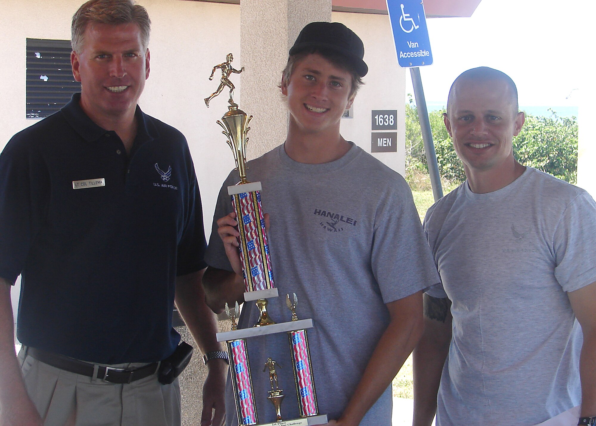 Justin McCormick, center, from Melbourne, Fla., shows off the first place trophy he won in the 333rd Recruiting Squadron’s Air Force Fitness Day H2F Olympics April 26 at Patrick Air Force Base, Fla. Lt. Col. Michael Tillema, left, 333rd RCS commander, and Master Sgt. Mike Kovach, “H” flight chief, presented the award to the high school student for making the best score in the competition based on Air Force Special Operations physical ability stamina tests. (U.S. Air Force photo/ Staff Sgt. Mike Burchfield)
