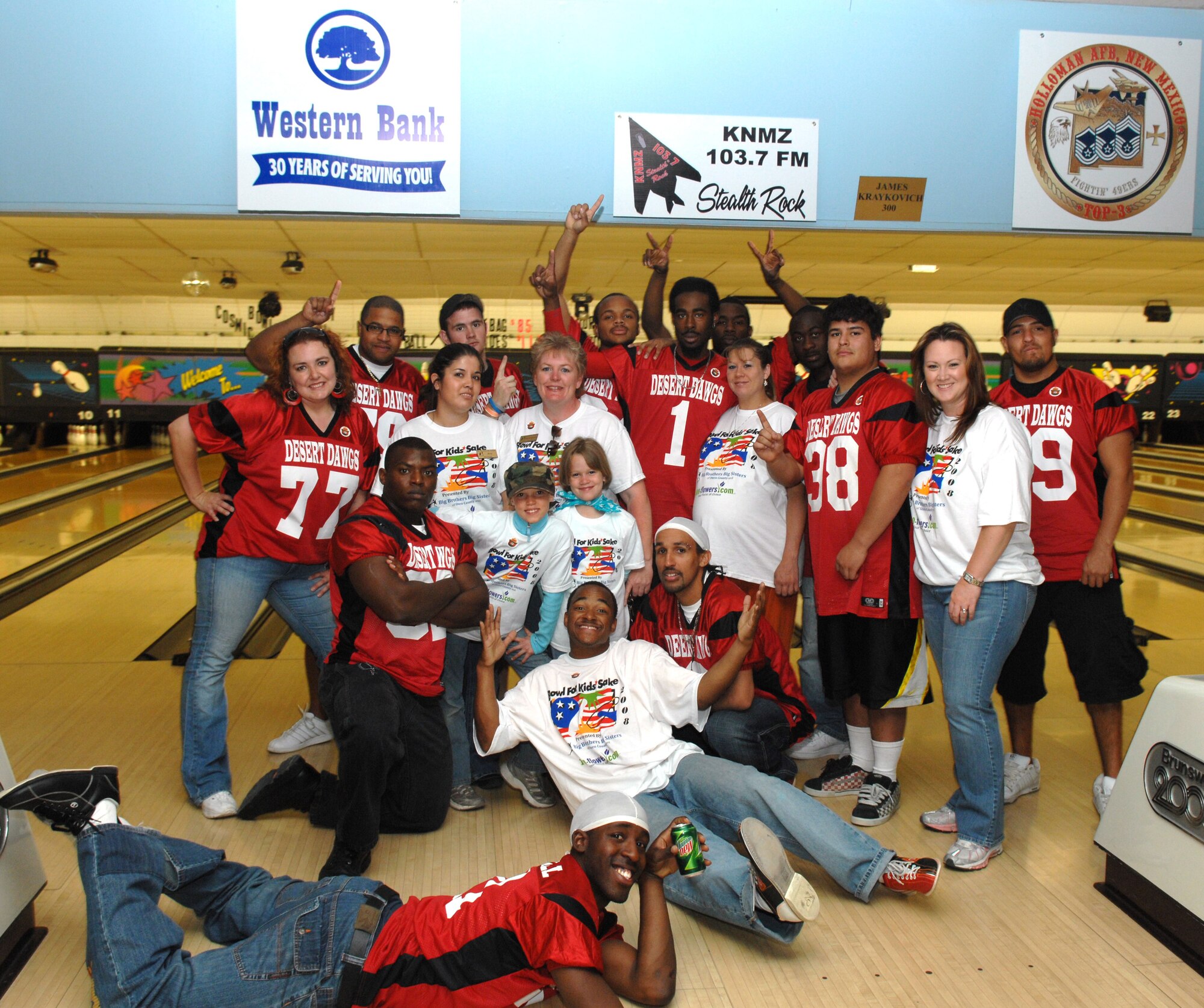 Members of the semi-pro football team Alamogordo Desert Dawgs and Big brother's Big sister's take a group photo during Bowl For Kid's Sake, presented by Big Brothers Big Sisters of Otero County April 14, 2008 at Holloman Air Force Base, N.M. These football players are members of the Semi-pro football team Alamogordo Desert Dawgs, volunteers for Big Brother's Big Sisters, prior active duty Air Force, Air Force dependents, and an active duty Air Force members. (U.S. Air Force photo/ Senior Airman Anthony Nelson Jr)
