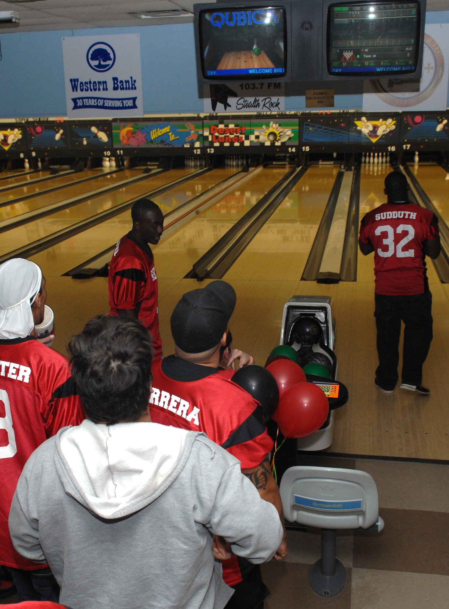 Members of the semi-pro football team Alamogordo Desert Dawgs watch as Staff Sergeant Patrick Sudduth, 49th Maintenance Operations Squadron, bowls during Bowl For Kid's Sake, presented by Big Brothers Big Sisters of Otero County April 14, 2008 at Holloman Air Force Base, N.M. Sgt Sudduth is a member of the Semi-pro football team Alamogordo Desert Dawgs, volunteer for Big Brother's Big Sisters, and an active duty Air Force member. (U.S. Air Force photo/ Senior Airman Anthony Nelson Jr)