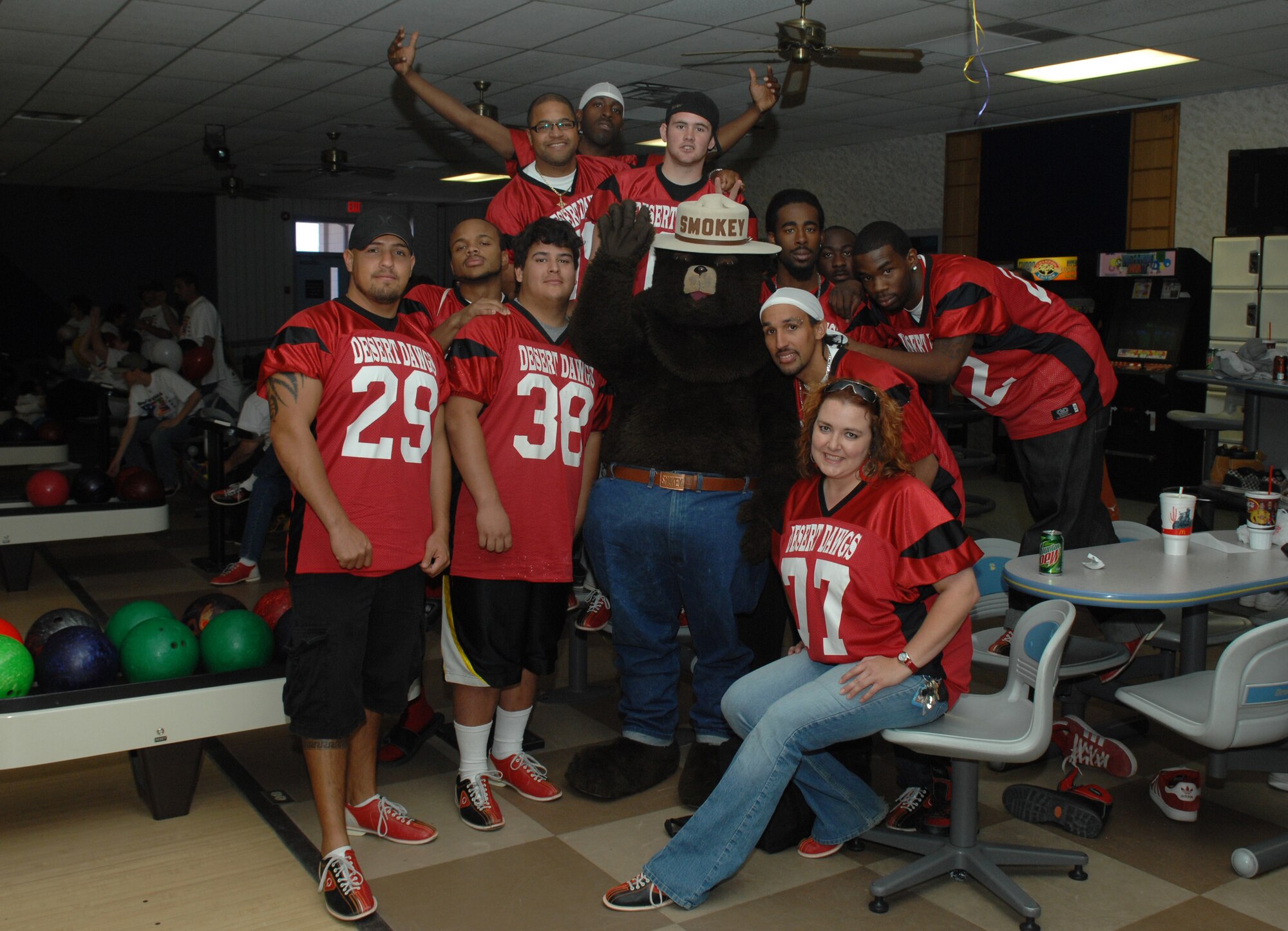 Members of the semi-pro football team Alamogordo Desert Dawgs take a group photo with Smokey the Bear during Bowl For Kid's Sake, presented by Big Brothers Big Sisters of Otero County April 14, 2008 at Holloman Air Force Base, N.M. These football players are members of the Semi-pro football team Alamogordo Desert Dawgs, volunteers for Big Brother's Big Sisters, prior active duty Air Force, Air Force dependents, and an active duty Air Force members. (U.S. Air Force photo/ Senior Airman Anthony Nelson Jr)