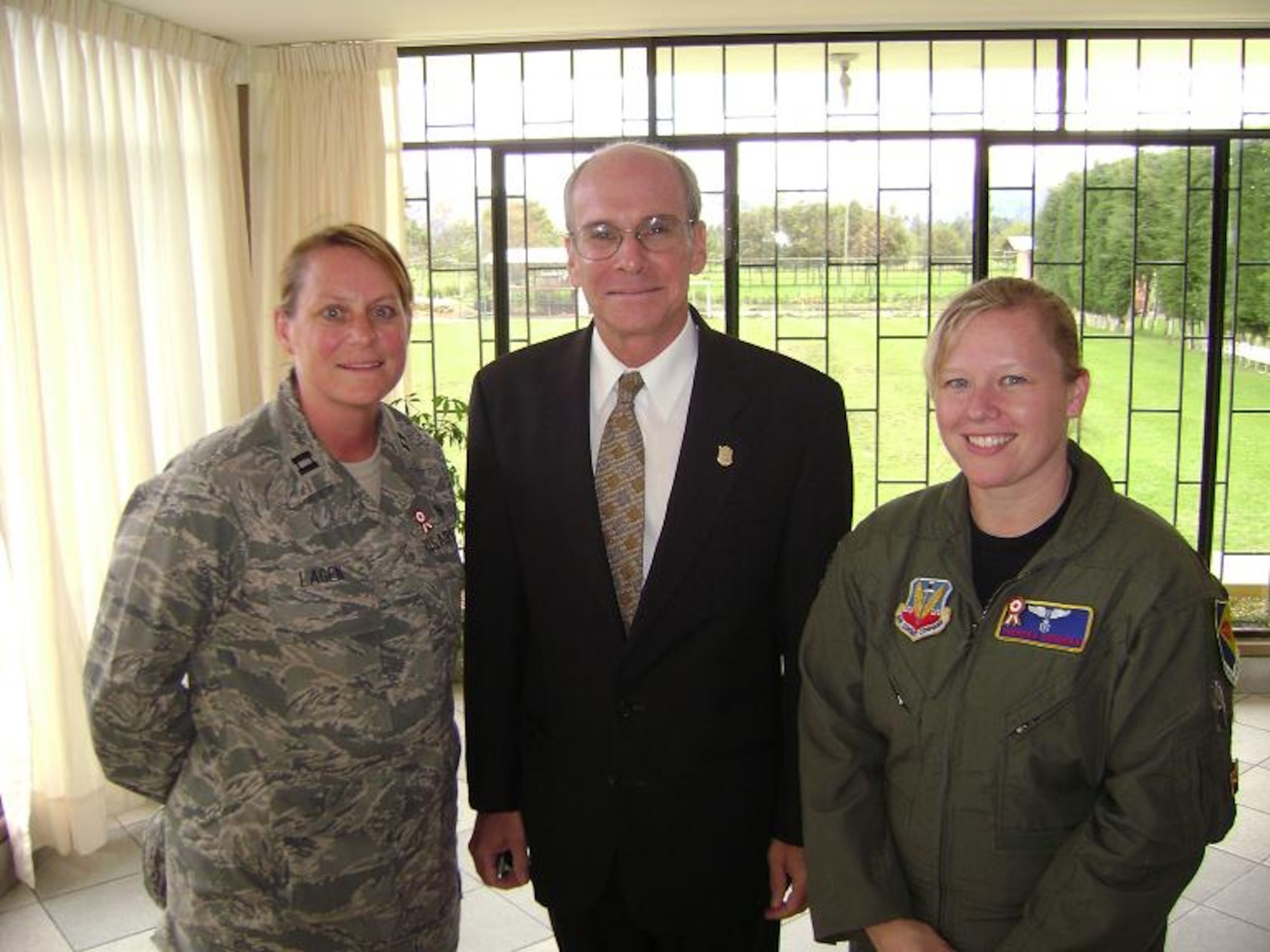 Capt. Erin Lagen, 355th Aerospace Medicine Squadron medical readiness flight commander and team lead, and Maj. Theresa Goodman, 355th AMDS flight surgeon and lead provider pose for a photo after lunch with the U.S. Ambassador to Peru, P. Michael McKinley. The team provided medical, dental, optometry services and medication to those less fortunate in local communities. (Courtesy photo)