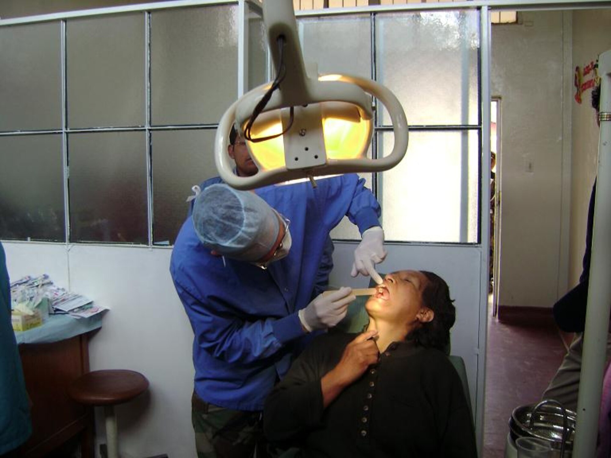 Lt. Col. (Dr.) Randall Griffin, a dentist from the 7th Aeromedical/Dental Squadron at Dyess Air Force Base, Texas, performs a dental exam on a patient during a MEDRETE April 2 to 19 in Cajamarca, Peru. The team of 15 medical professionals provided free medical treatment to more than 4,400 patients in 10 days. (Courtesy photo)