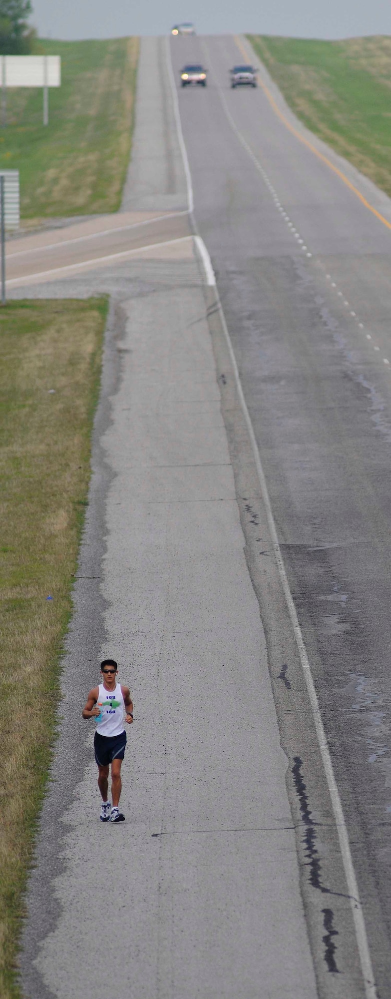 Senior Airman Brendan Brustad of Altus Air Force Base makes his way eastward on U.S. 62 on day two of his 168-mile journey in honor of the victims of the April 19, 1995, bombing of the Alfred P. Murrah Federal
Building in Oklahoma City.

