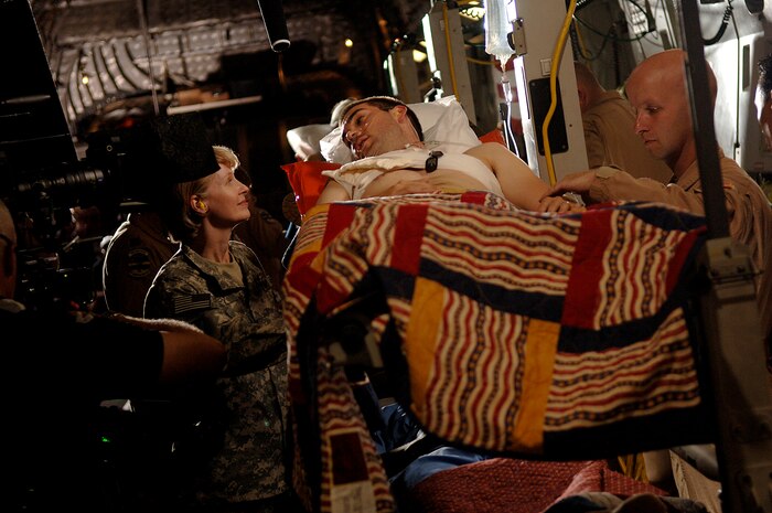 Master Sgt. Bart Walters, a reservist assigned to the 315th AES, (right) provides care for actor Drew Fuller while actress Catherin Dyer (left) looks on.  Scenes from the Lifetime drama, Army Wives, were filmed on the Charleston Air Force Base, S.C., flightline May 5, 2008.  (U.S. Air Force photo/Senior Airman Nicholas Pilch)