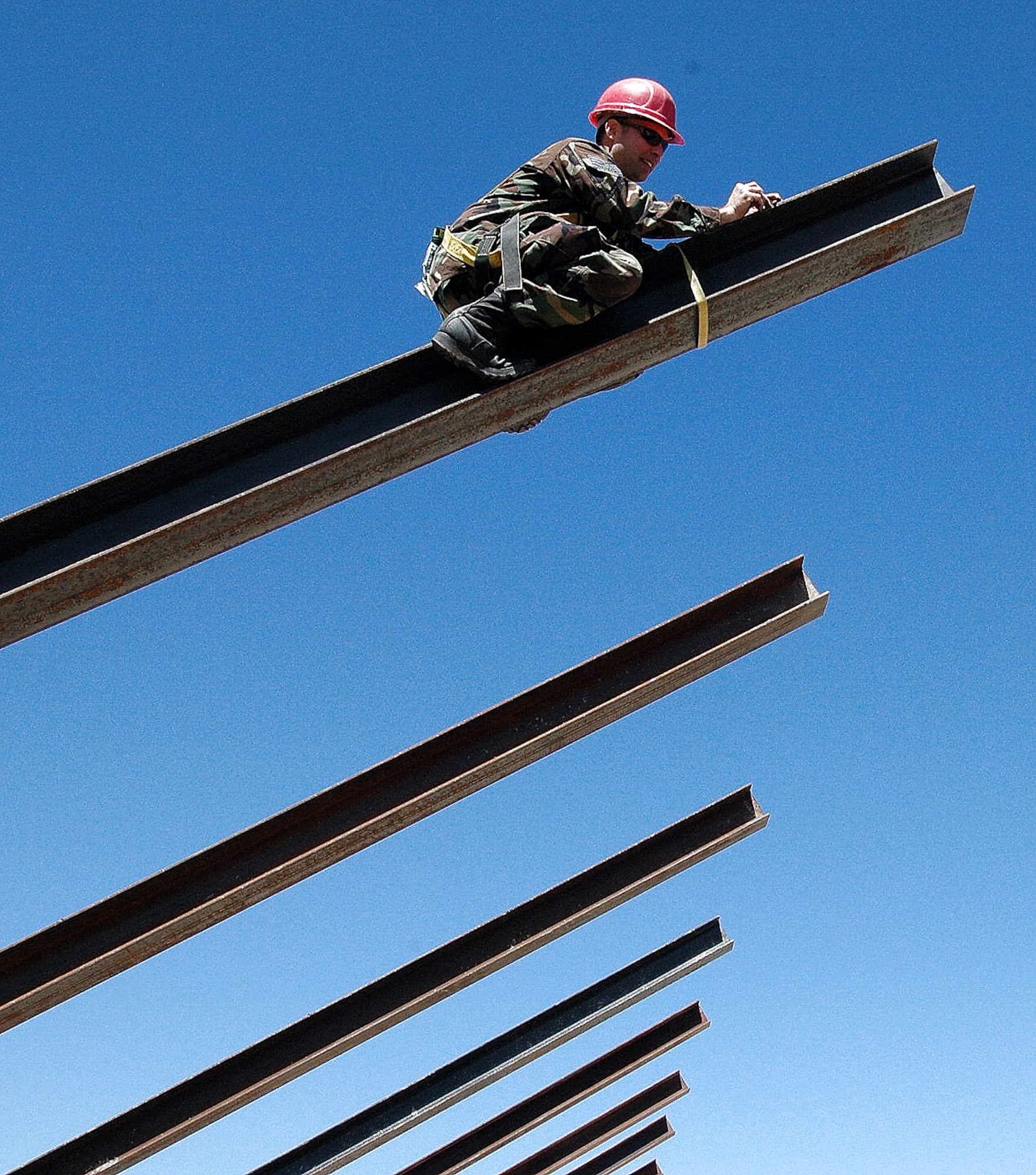 Staff Sgt. George Thompson marks a steel beam with chalk so it can be cut to its proper length May 1 near Campo, Calif. The beams will be used to finish off an "eyebrow" to a firing range that will allow Border Patrol officers to hone in their weapons skills. Sergeant Thompson is an engineering assistant for the 201st RED HORSE Squadron from Fort Indiantown Gap, Pa. (U.S. Air Force photo/1st Lt. Jay Ostrich)
