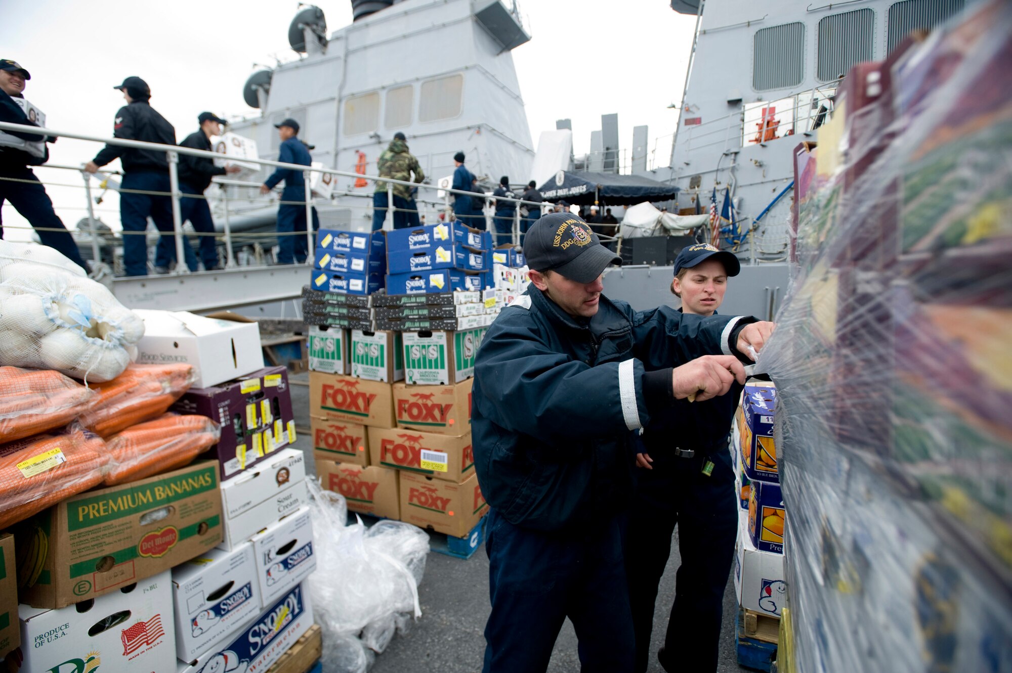 SEWARD, Alaska—Seaman Jason Hobart cuts plastic wrap to help load food onto John Paul Jones at Seward's harbor on May 3, 2008. The John Paul Jones an Arleigh Burke class destroyer will be participating Northern Edge, Alaska’s largest joint training exercise focusing on execution of tactical level and joint interoperability. (U.S. Air Force Photo by Airman 1st Class Jonathan Steffen)(RELEASED)