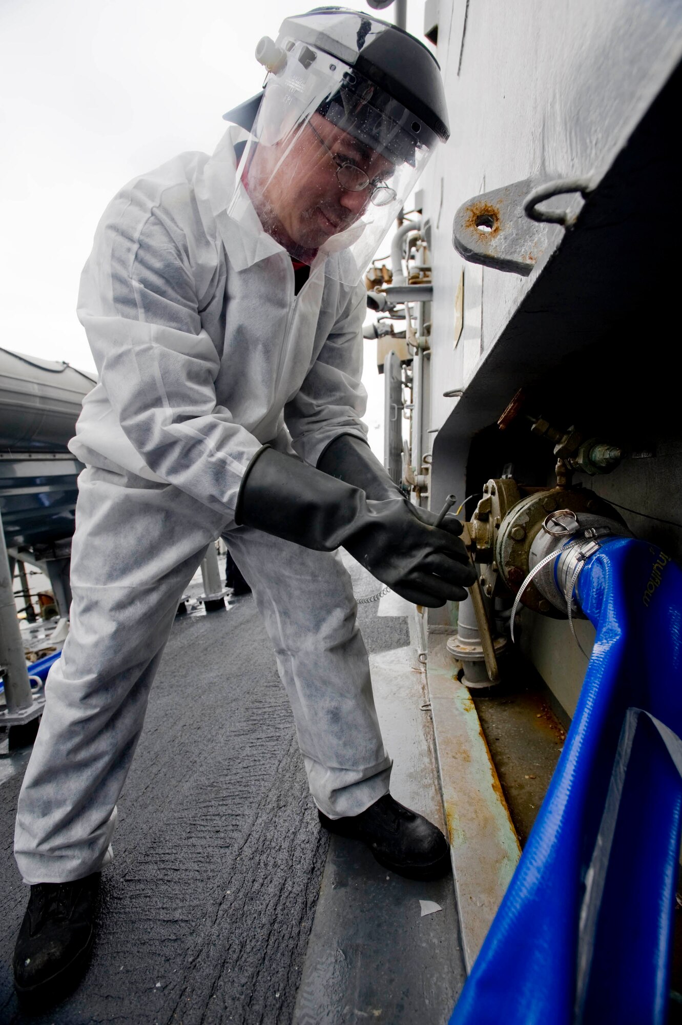 SEWARD, Alaska—Seaman Sean Walker on board John Paul Jones tightens sewage line to prepare to offload its sewage while docked at Seward's harbor on  May 3, 2008. The John Paul Jones a Arleigh Burke class destroyer will be participating Northern Edge, a two week joint exercise allows U.S. forces to train for regional and world wide crisis.(U.S. Air Force Photo by Airman 1st Class Jonathan Steffen)(RELEASED)
