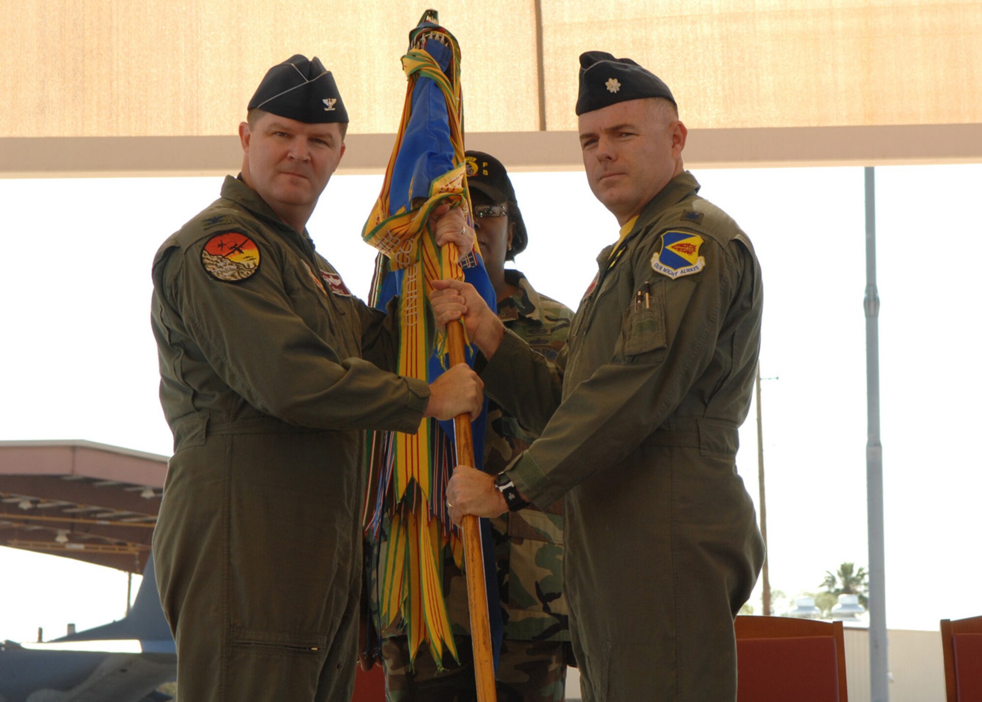 Lt. Col. Clifford Bowman (right) receives the 357th Fighter Squadron guidon from the 355th Operations Group Commander Colonel Thomas Deale during a change-of-command ceremony on the flight line here May 2. Colonel Bowman assumed command of the 357th FS from Lieutenant Colonel Scott Stark.  (U.S. Air Force photo by Senior Airman Alesia Goosic)