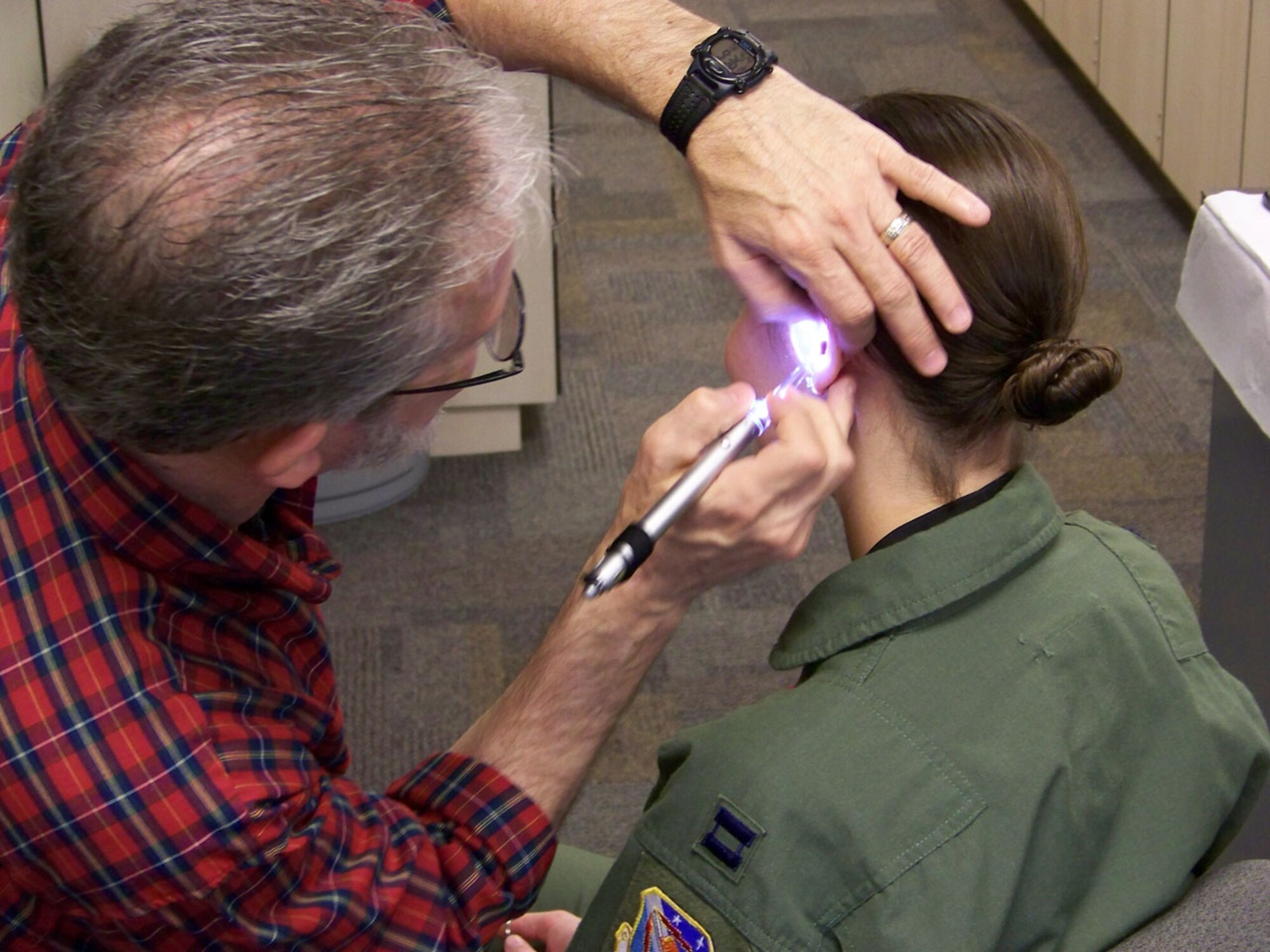 Michael West, Westone Laboratories technician, prepares Capt. Mary Hill, 53rd Test Management Group/Detachment 1 (attached to the 49th Test Squadron, Barksdale AFB, La.), for her custom earpiece fittings Thursday, April 24. Captain Hill is one of approximately 300 Barksdale Airmen who now have the opportunity to be "fitted" by Westone trained, 2d Medical Group personnel. (U.S. Air Force photo/Master Sgt. Sherri Bohannon)