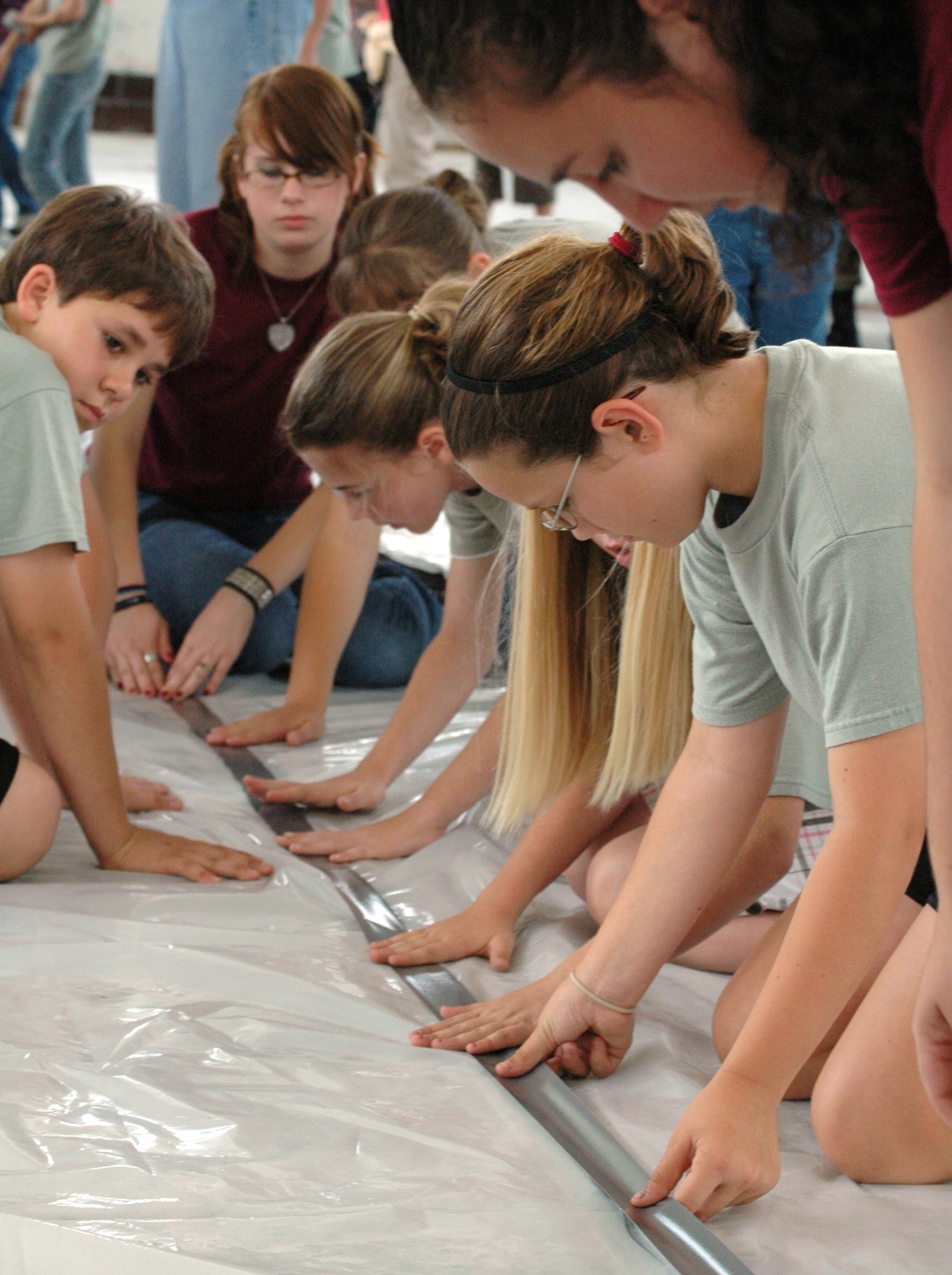 EGLIN AIR FORCE BASE -- Fifth graders from Valparaiso Elementary School, with the help of JROTC students from Niceville High School, hustle to complete an artificial habitat, much like ones that would sustain life on Mars. Marsville is a collaborative effort between Eglin Air Force Base and the surrounding elementary school's fifth graders that provides students to explore the possibilities of inhabiting Mars.