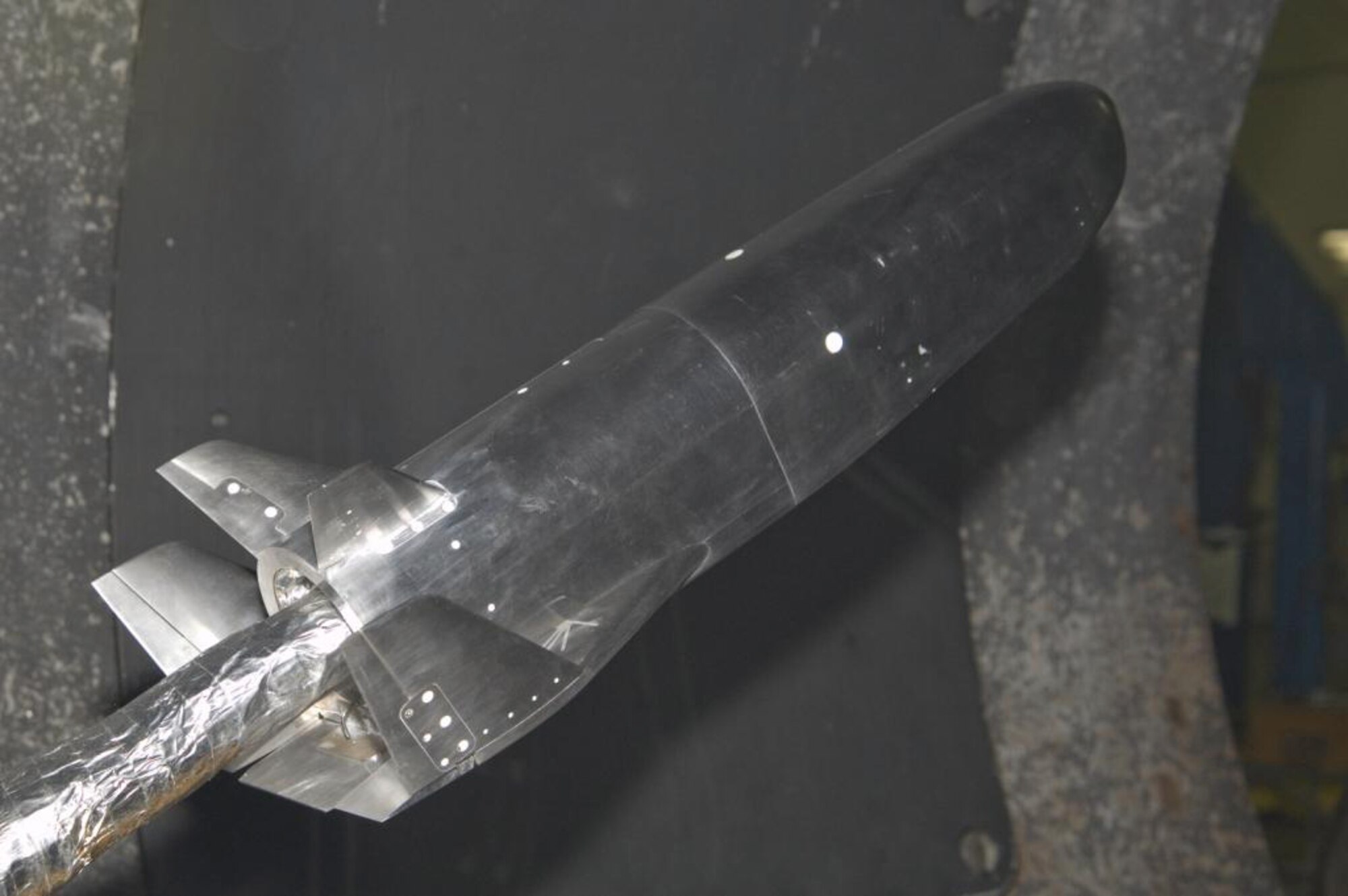 A hypersonic vehicle model undergoes wind tunnel testing.