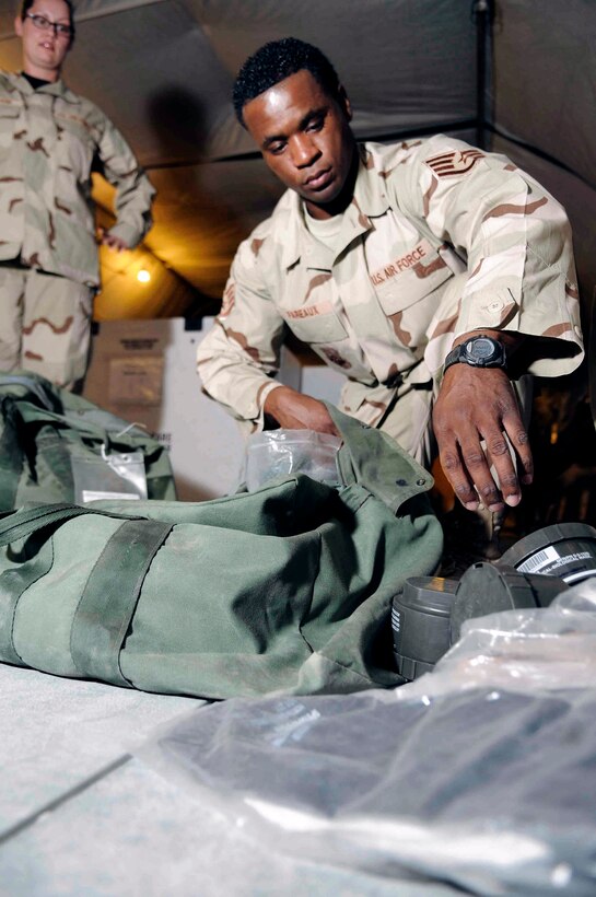 Staff Sgt. Julio Fareaux inspects a bag to ensure every item is present and not past its expiration date April 29 at a Southwest Asia air base. Sergeant Fareaux, assigned to the 379th Expeditionary Logistics Readiness Squadron, and his team help up to 150 customers an hour returning from the area of responsibility. (U.S. Air Force photo/Tech. Sgt. Johnny Saldivar) 