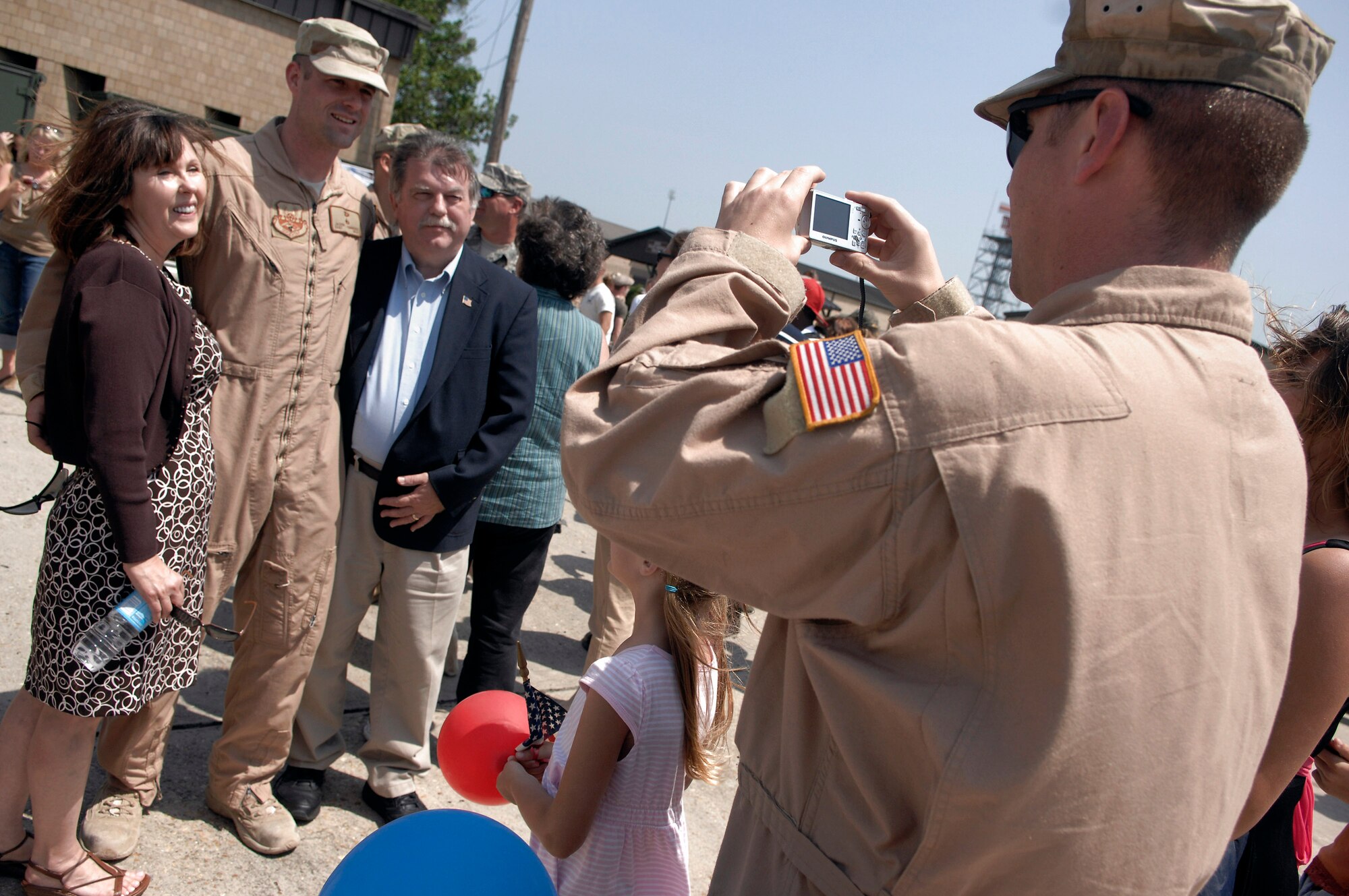 An Airman from the 823rd Security Forces Squadron takes a photo of another squadron member during a homecoming ceremony April 29 at Moody Air Force Base, Ga. Members of the 823rd SFS recently returned from a six-month deployment at Camp Bucca, Iraq. (U.S. Air Force photo/Senior Airman Gina Chiaverotti) 
