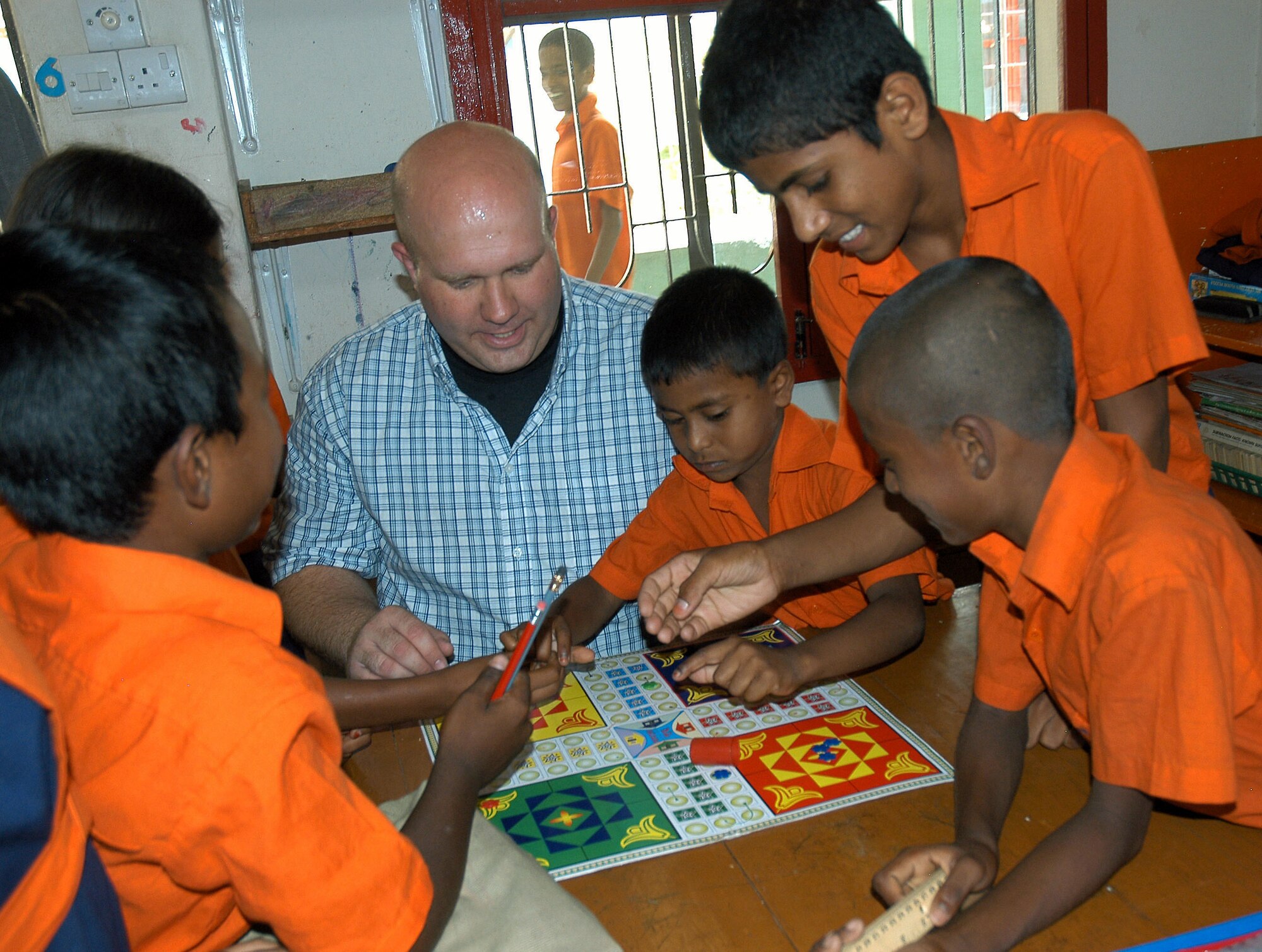 Capt. Darin Wheeler plays a game with fifth graders from Eglal's ABC School April 27 in Dhaka, Bangladesh. Captain Wheeler and members of the 353rd Special Operations Group are in Bangladesh for joint combined exercise training with the Bangladesh air force. (U.S. Air Force photo/Master Sgt. Marilyn Holliday) 
