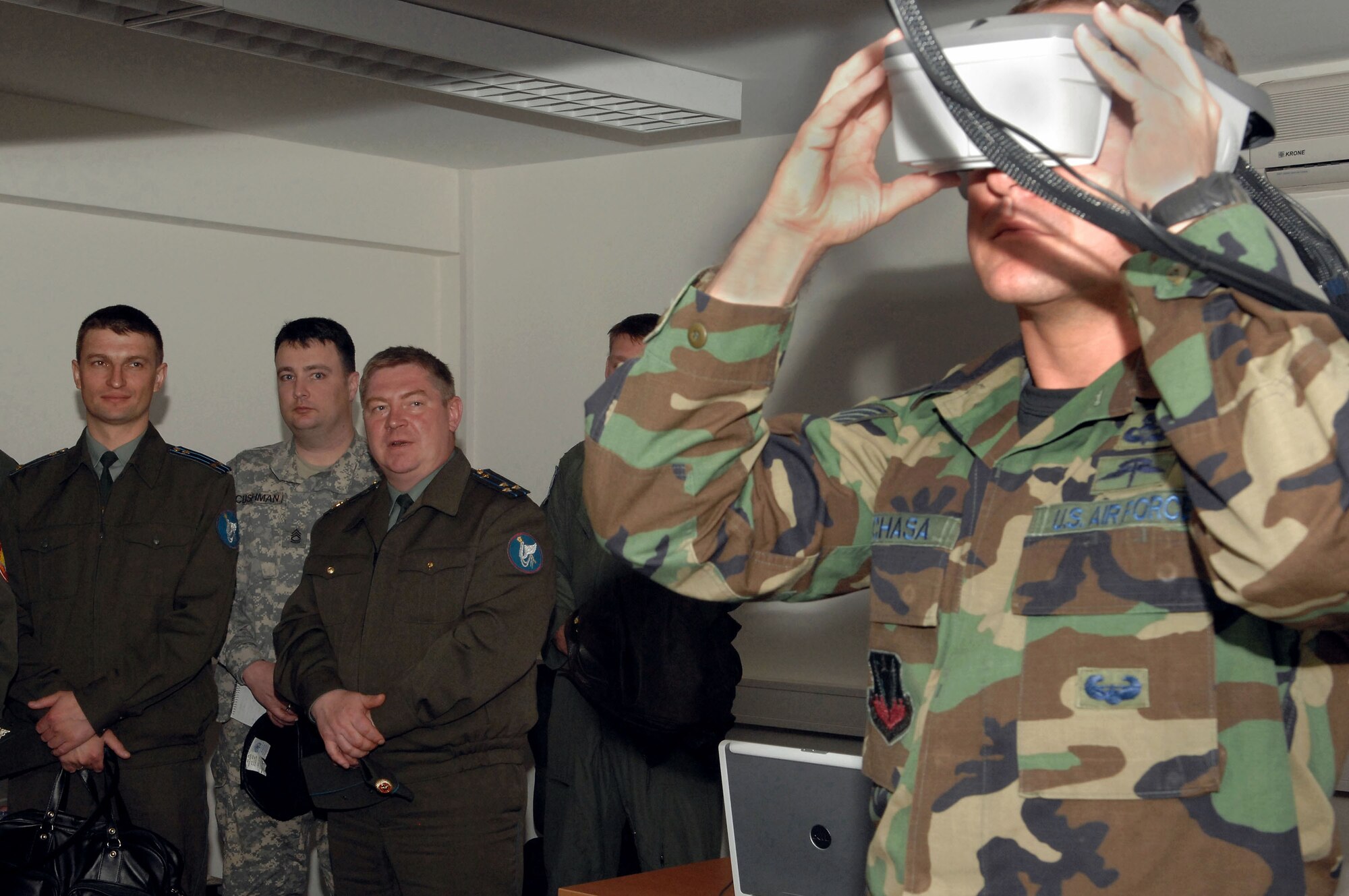 Russian Lt. Col. Sergey Izvenkov and Russian Col. Aleksandu Razygraeu observe as Tech. Sgt. Timothy Pachasa demonstrates the use of the Indirect Fire Forward Air Control Trainer simulator April 30 at the Joint Fighters Center for Excellence at Spangdahlem Air Base, Germany. The simulator is a procedural trainer that simulates close-air support and indirect fires. Sergeant Pachasa is a joint terminal attack instructor at the U.S. Air Forces in Europe Air Ground Operations School from Fort Bliss, Texas. (U.S. Air Force photo/Senior Airman Logan Tuttle) 

