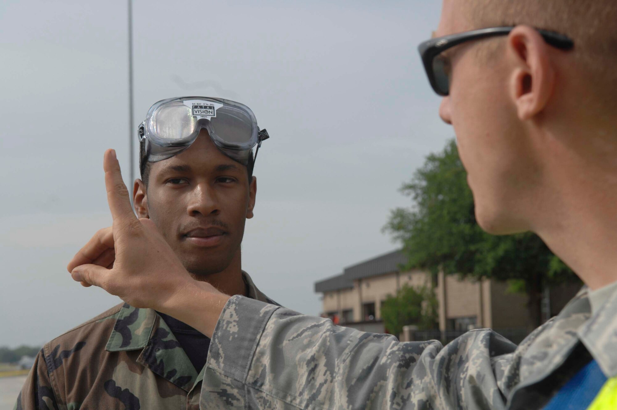 SHAW AIR FORCE BASE, S.C.-- Airman 1st Class Justin Harrison, 20th Communications Squadron base radio technician, performs a field sobriety test by following a moving finger with his eyes as Staff Sgt. Seth Rosebrook, 20th Security Forces officer, explains the possible consequences of driving under the influence during Safety Day May 2. Safety Day is an opportunity for Shaw members to prepare for 101 critical days of summer with information on everything from outdoor activities to installing a child safety seat. (U.S. Air Force photo/Staff Sgt. Nathan Bevier)