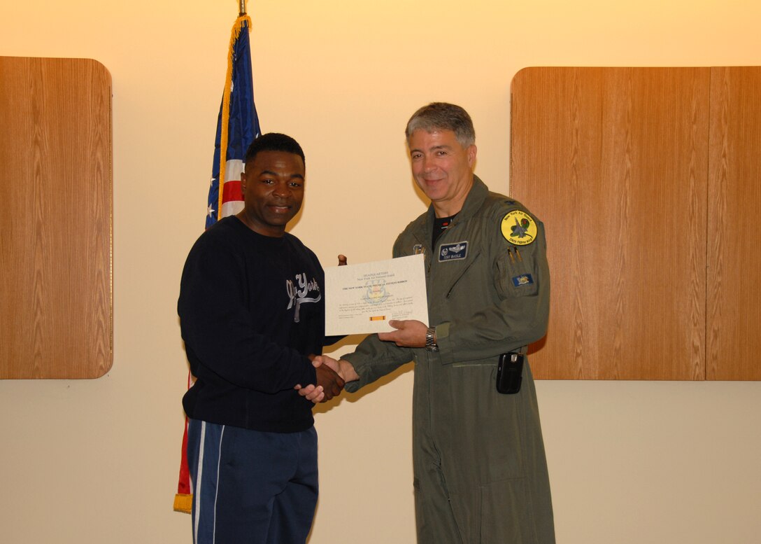 Capt. Gary Richardson, 174 FW Social Actions Officer is awarded the New York State Physical Fitness Ribbon by 174 FW Commander Anthony B. Basile during a ceremony at Hancock Field Air National Guard Base on Saturday the Third of May.